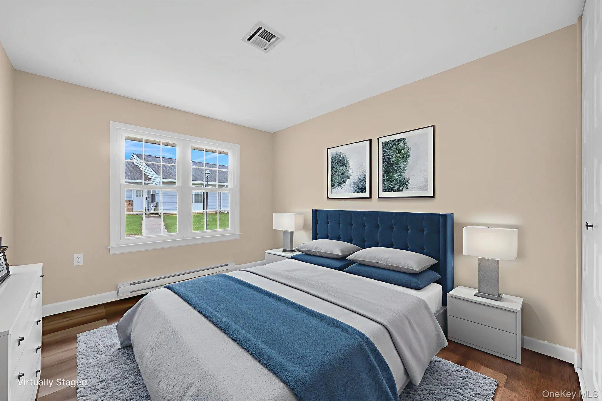Bedroom featuring a baseboard heating unit and dark wood finished floors Bedroom featuring a baseboard heating unit and dark wood finished floors