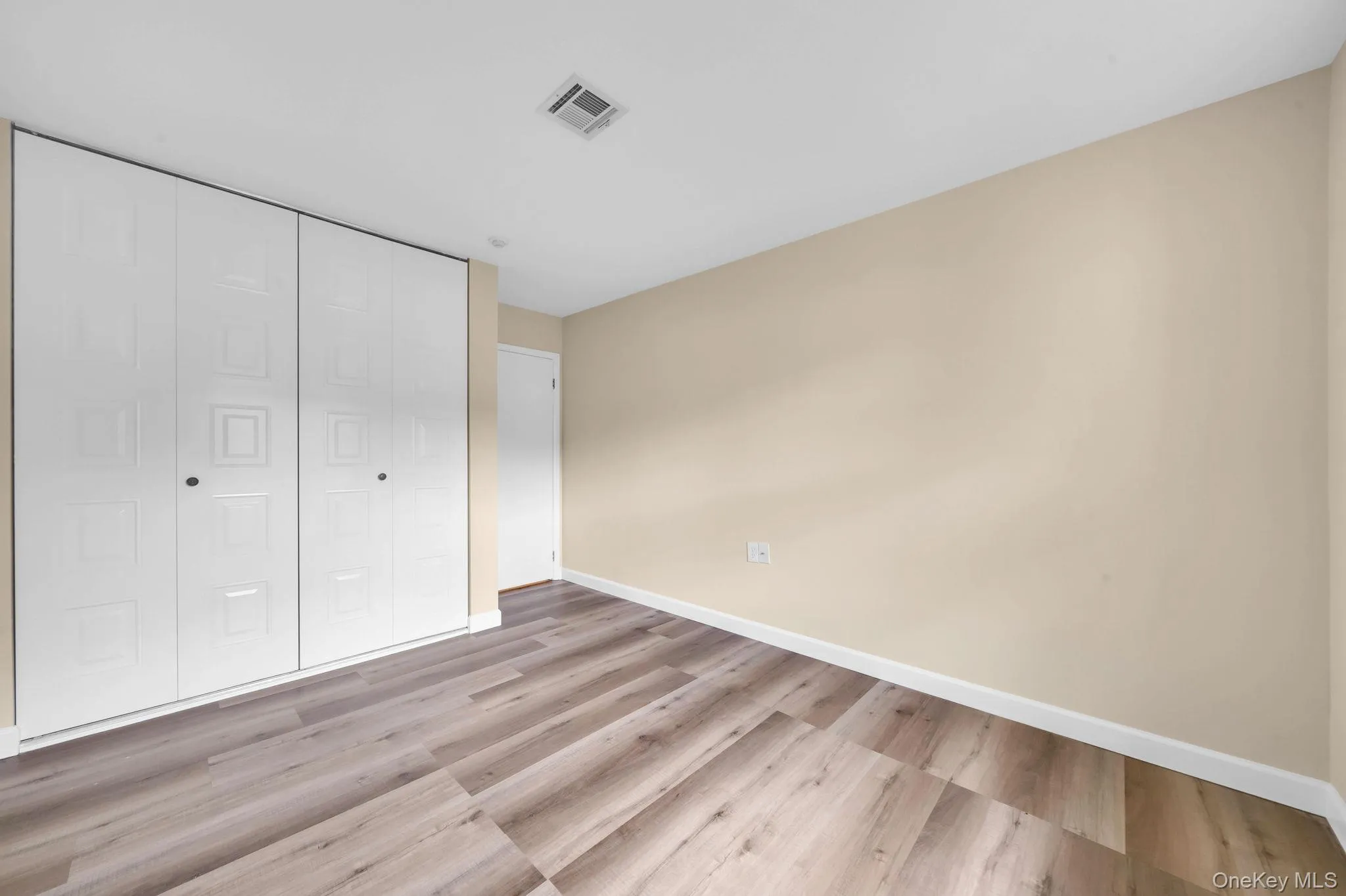Unfurnished bedroom featuring light wood-type flooring and a closet Unfurnished bedroom featuring light wood-type flooring and a closet