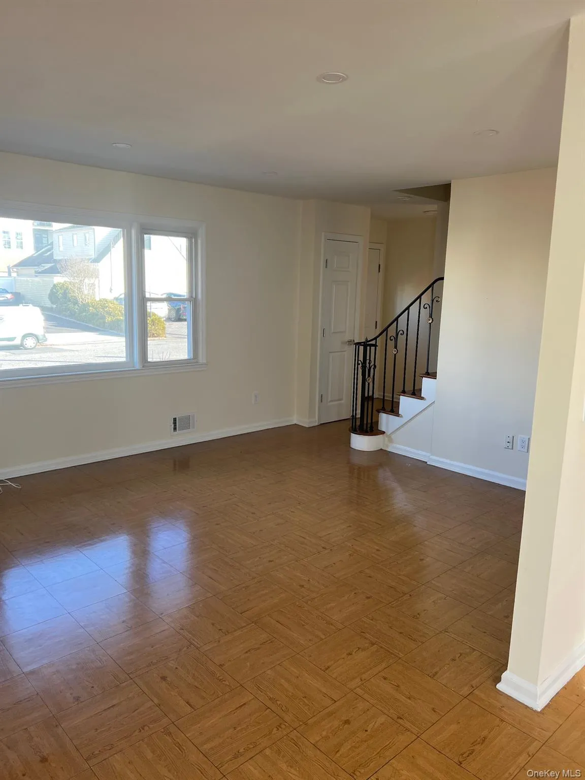 Unfurnished living room featuring baseboards and stairs Unfurnished living room featuring baseboards and stairs