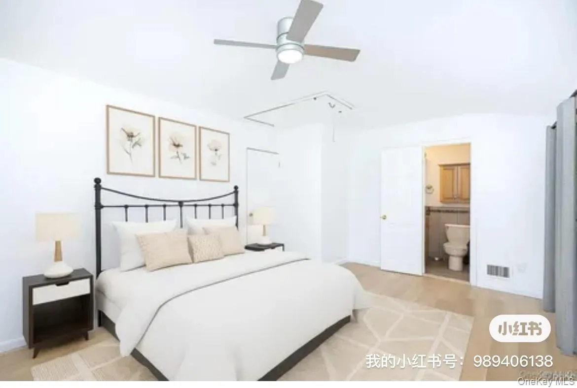 Bedroom featuring attic access, a ceiling fan, connected bathroom, and light wood-style flooring Bedroom featuring attic access, a ceiling fan, connected bathroom, and light wood-style flooring
