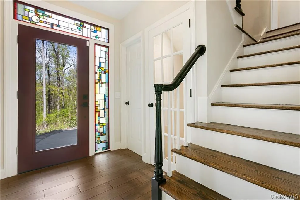 Entrance foyer with stairs and dark wood finished floors Entrance foyer with stairs and dark wood finished floors