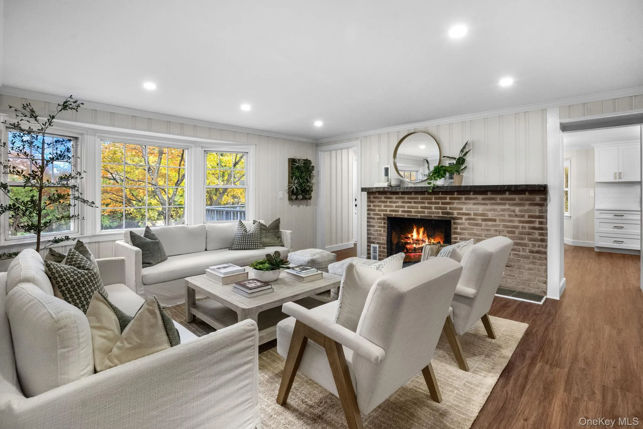 A beautifully reimagined living space filled with natural light, where wide picture windows and a glowing fireplace create the perfect spot to unwind. A beautifully reimagined living space filled with natural light, where wide picture windows and a glowing fireplace create the perfect spot to unwind.