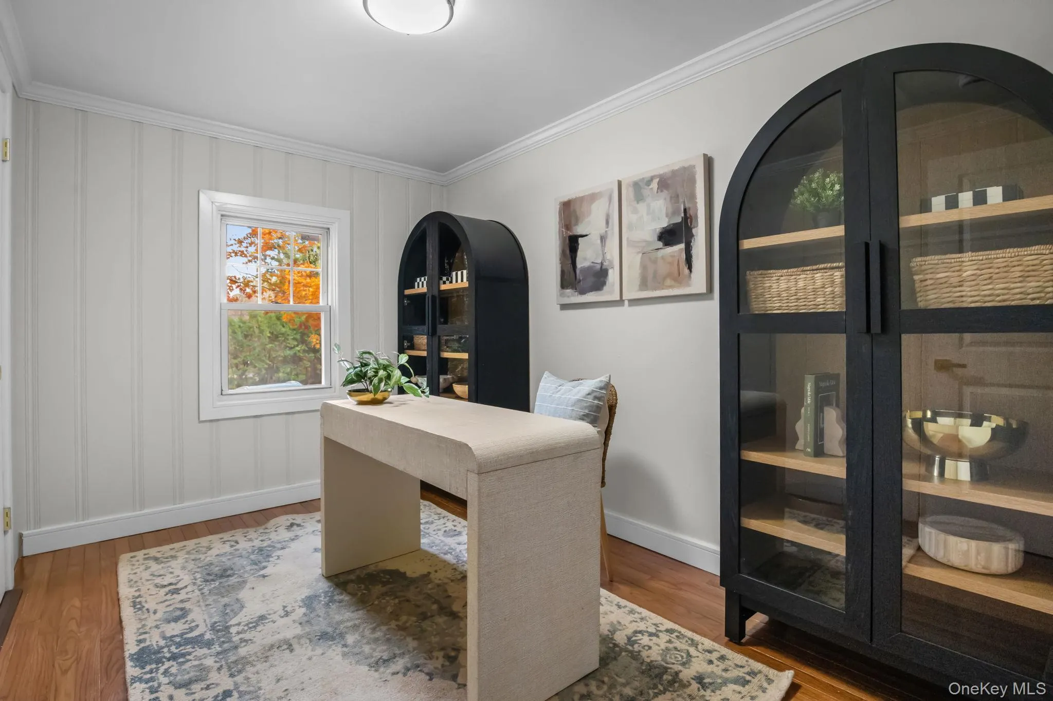 Flexible home office with hardwood floors, crown molding, and natural light creating an ideal workspace or study area. Flexible home office with hardwood floors, crown molding, and natural light creating an ideal workspace or study area.