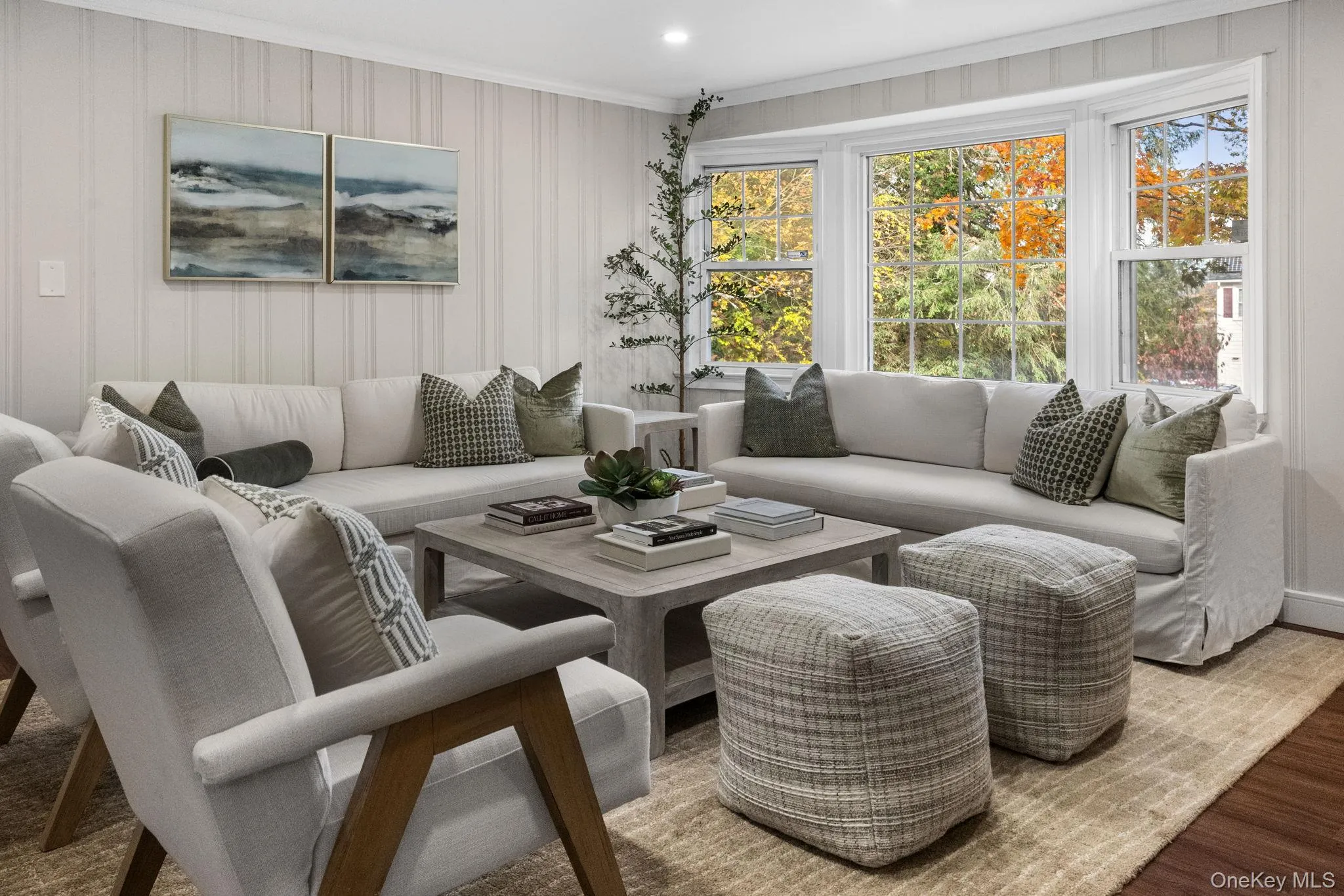 Bright and comfortable living room showcasing timeless updates and a peaceful view of the tree-lined property. Bright and comfortable living room showcasing timeless updates and a peaceful view of the tree-lined property.