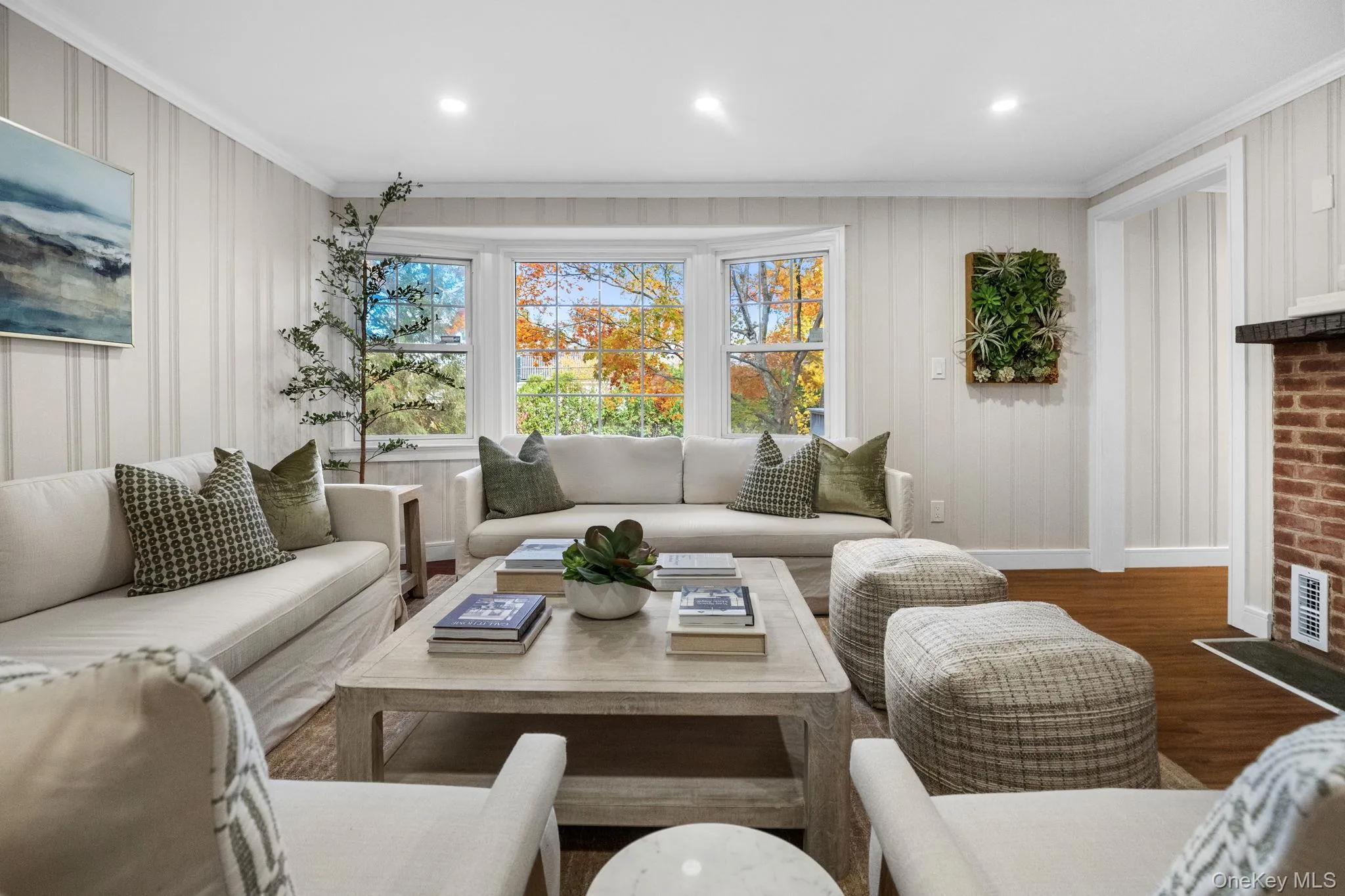 Newly renovated living room featuring a large bay window that fills the space with natural light for an inviting, relaxed atmosphere. Newly renovated living room featuring a large bay window that fills the space with natural light for an inviting, relaxed atmosphere.