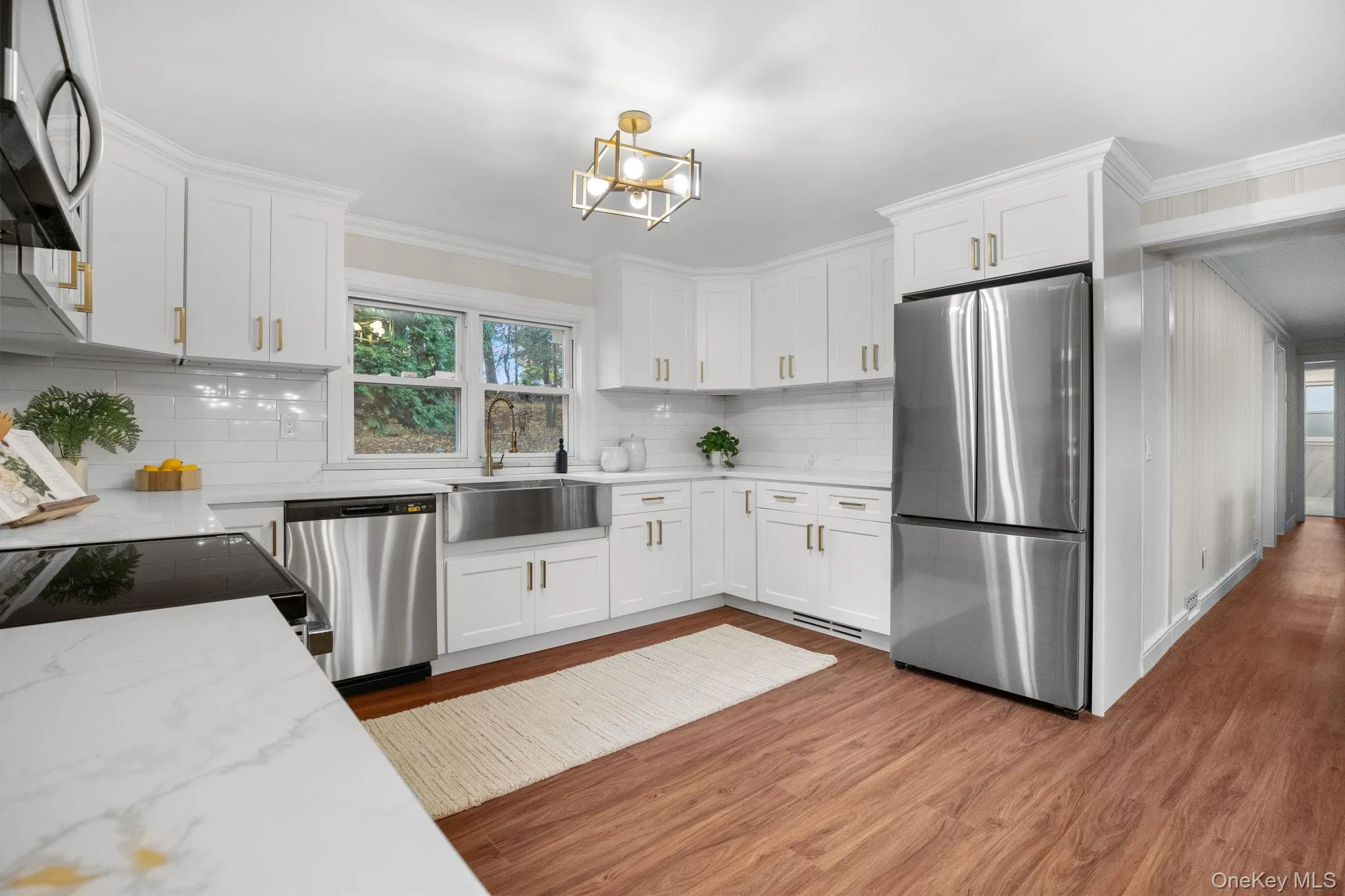 Beautifully renovated kitchen with an open layout, quartz countertops, and stainless steel appliances creating a bright and functional gathering space. Beautifully renovated kitchen with an open layout, quartz countertops, and stainless steel appliances creating a bright and functional gathering space.