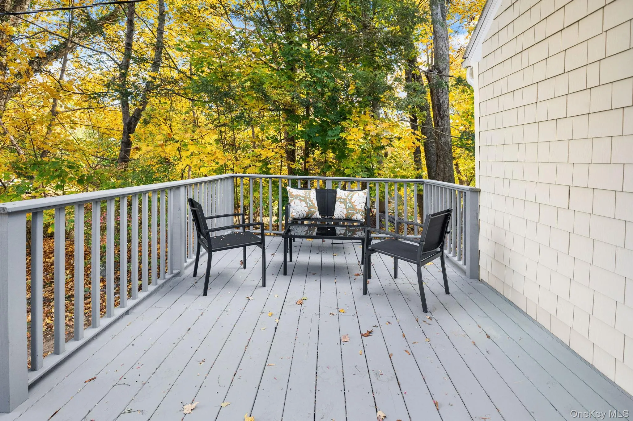 Freshly painted front porch surrounded by mature trees, offering a peaceful spot to enjoy morning coffee or unwind outdoors. Freshly painted front porch surrounded by mature trees, offering a peaceful spot to enjoy morning coffee or unwind outdoors.