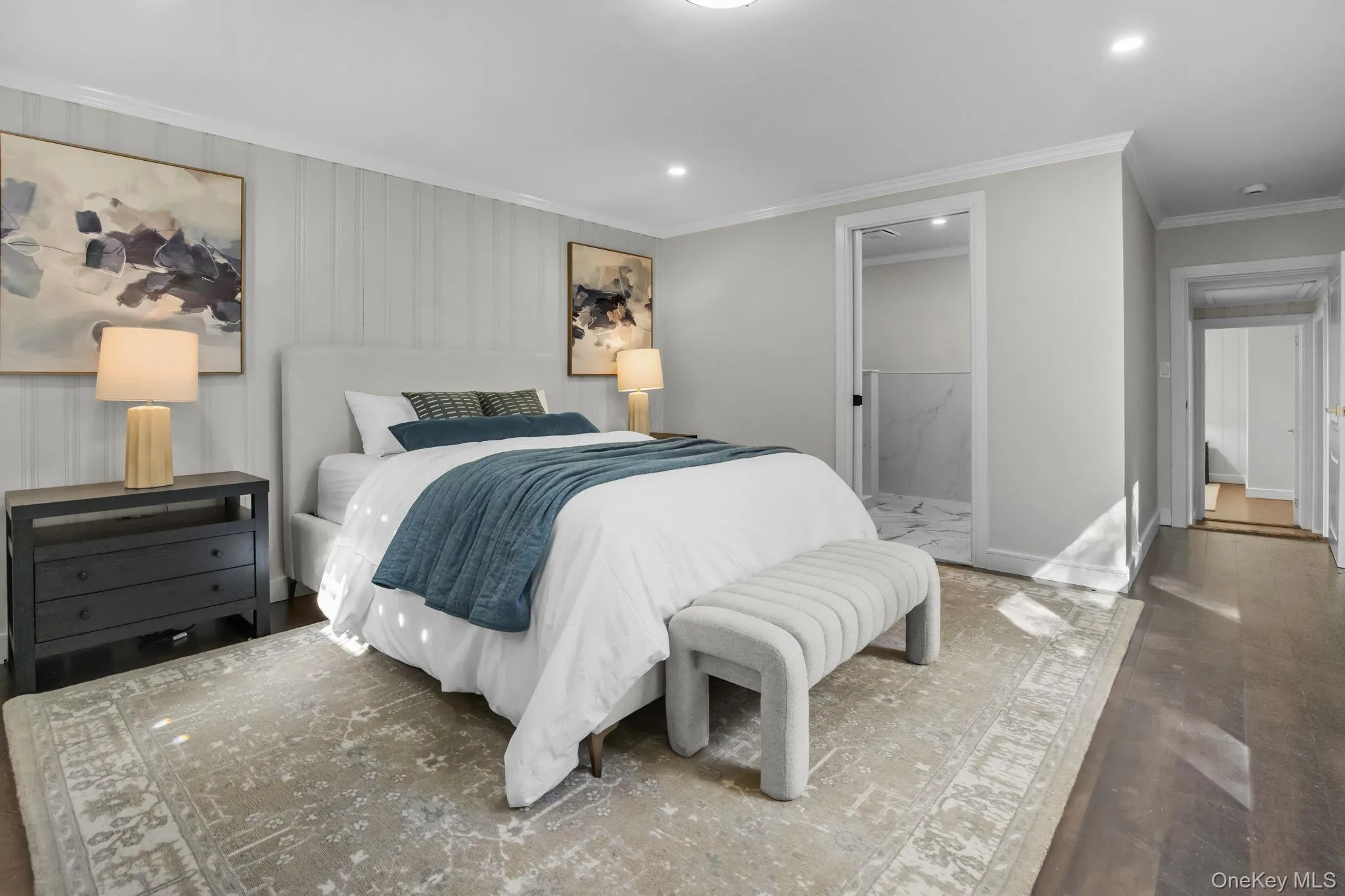 Bright and spacious primary bedroom with hardwood floors, crown molding, and direct access to the ensuite bath. Bright and spacious primary bedroom with hardwood floors, crown molding, and direct access to the ensuite bath.