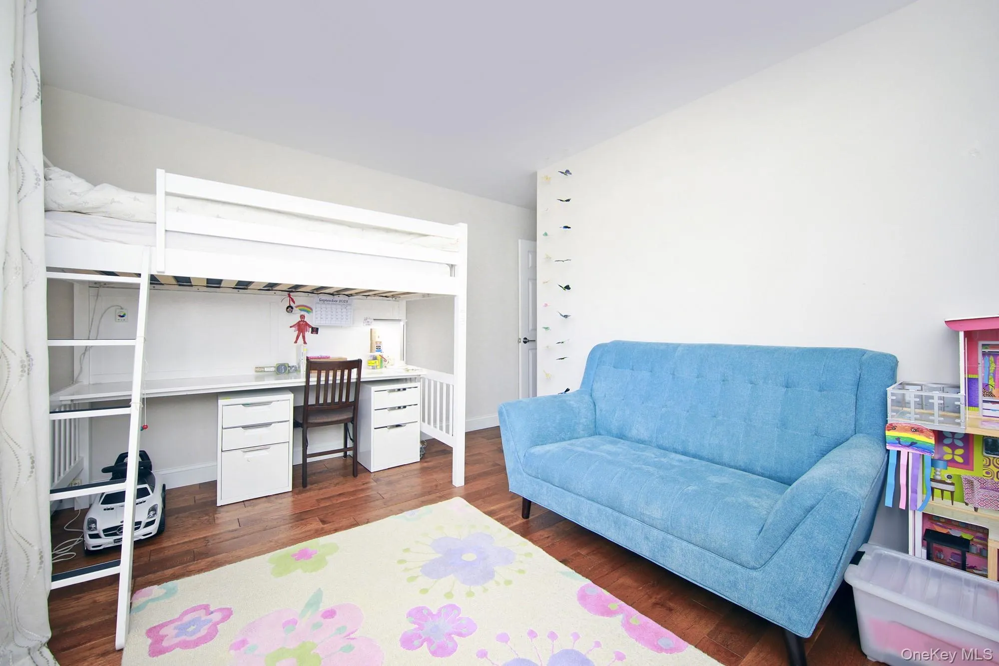 Bedroom featuring dark wood-style floors and a desk Bedroom featuring dark wood-style floors and a desk