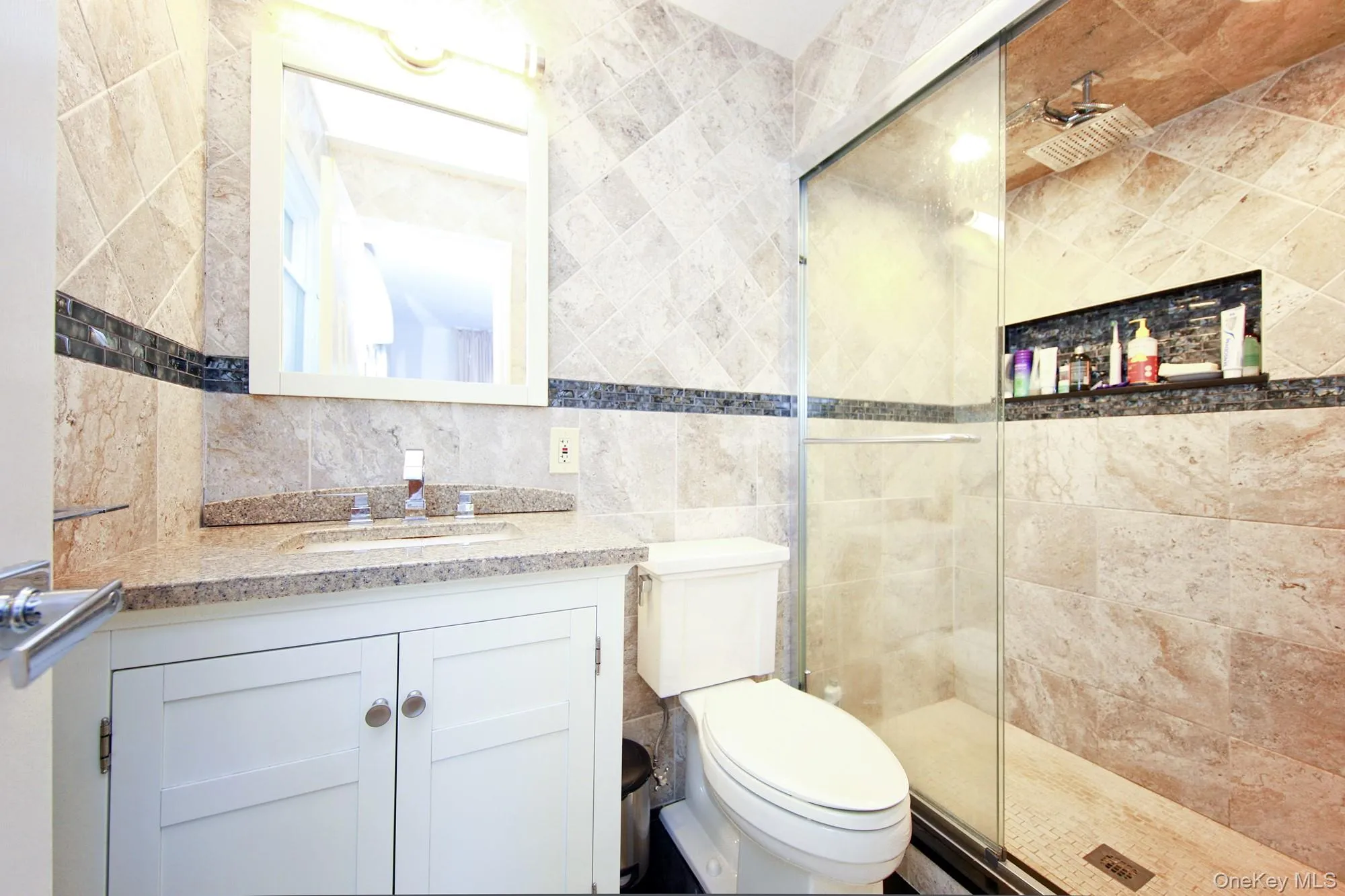 Full bathroom featuring tile walls, vanity, and a shower stall Full bathroom featuring tile walls, vanity, and a shower stall