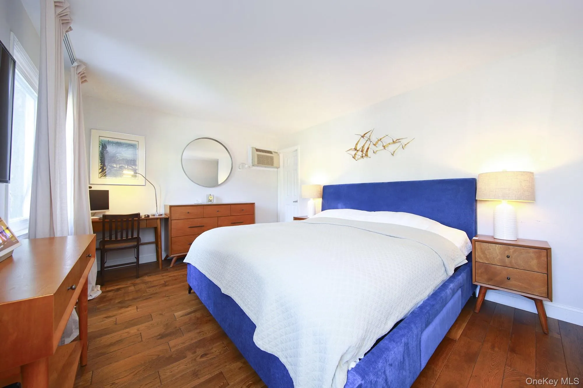 Bedroom featuring dark wood-style flooring and a wall mounted AC Bedroom featuring dark wood-style flooring and a wall mounted AC