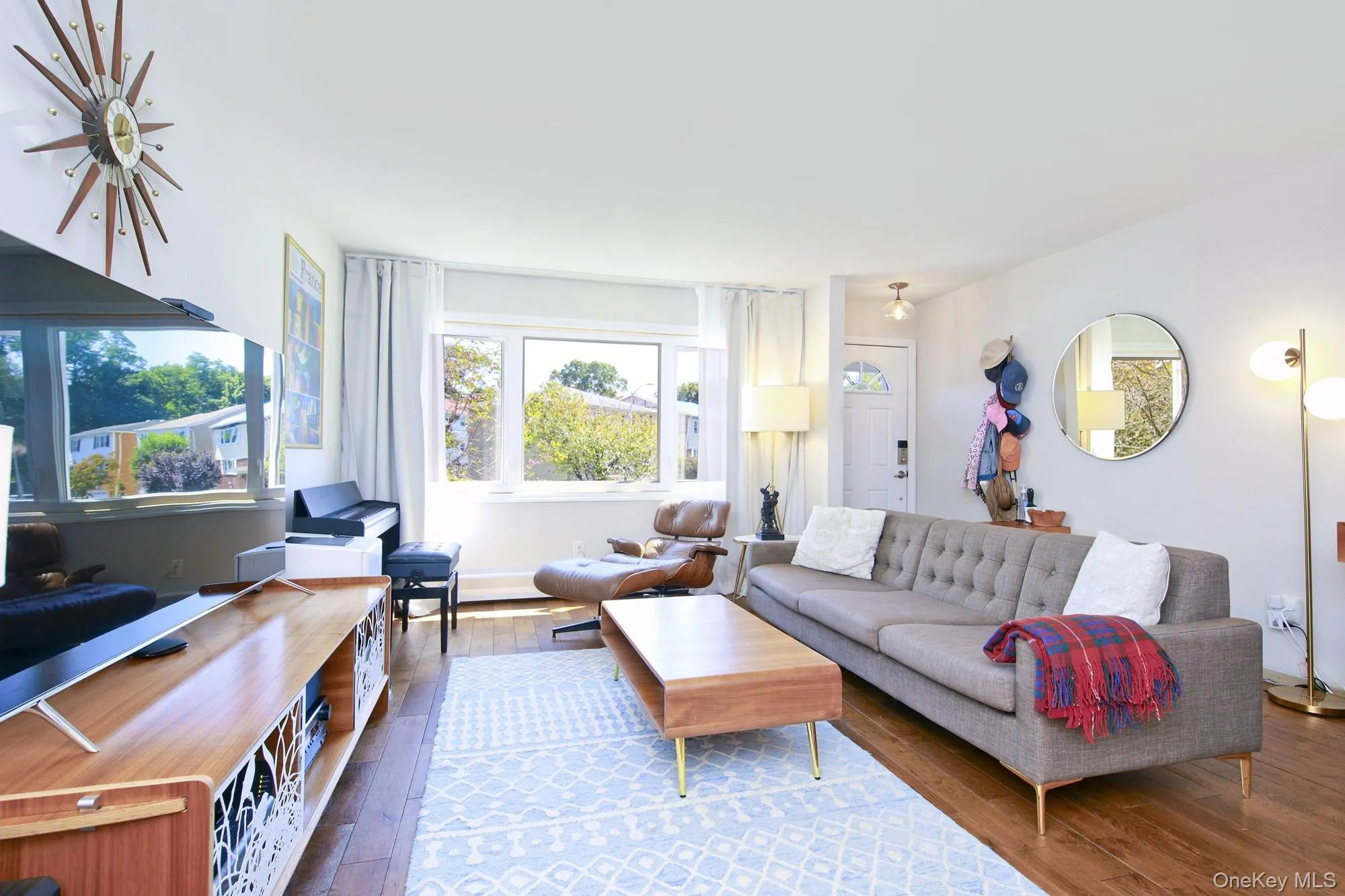 Living area with healthy amount of natural light and dark wood-style flooring Living area with healthy amount of natural light and dark wood-style flooring