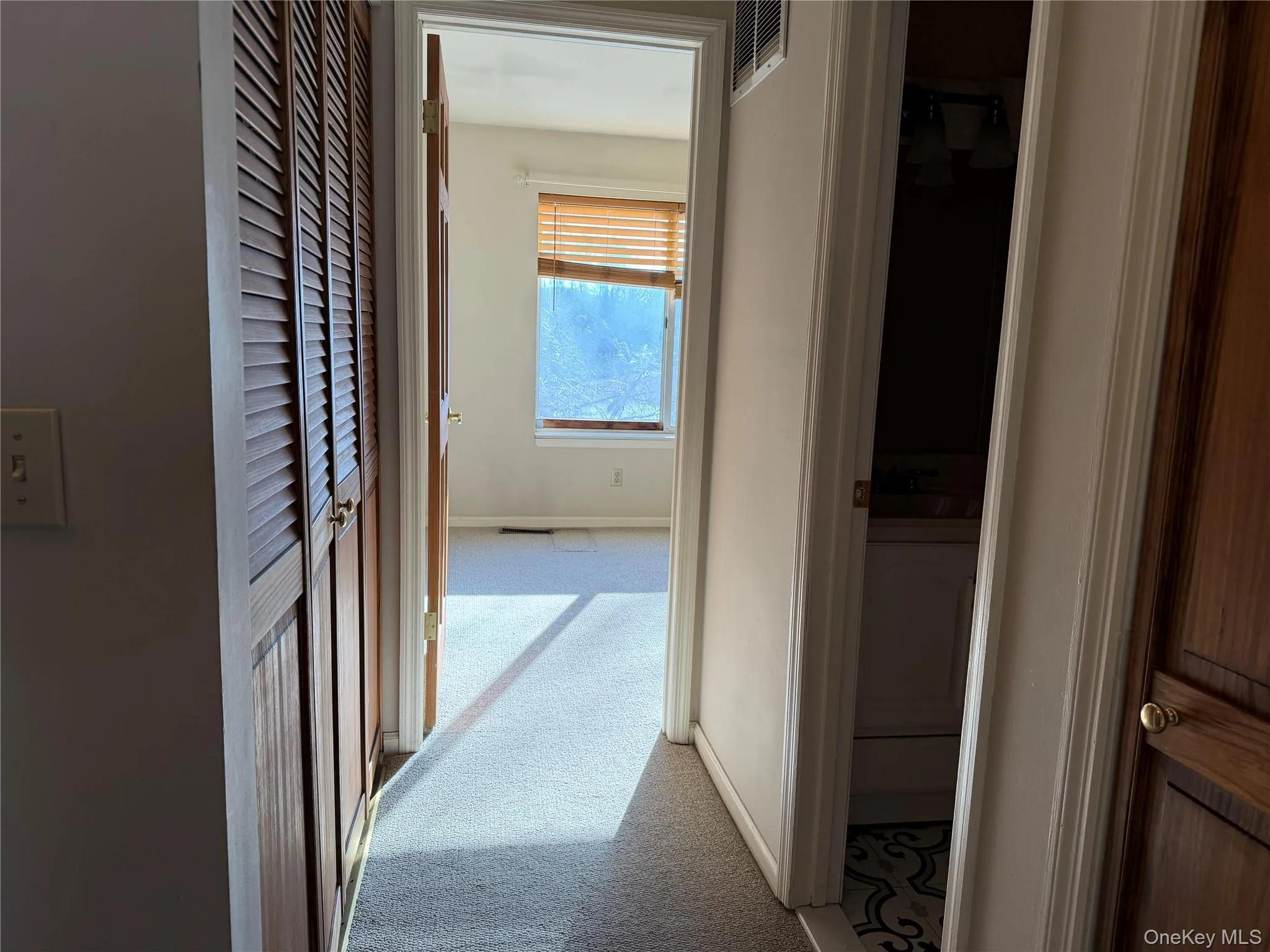 Corridor with light carpet and baseboards Corridor with light carpet and baseboards