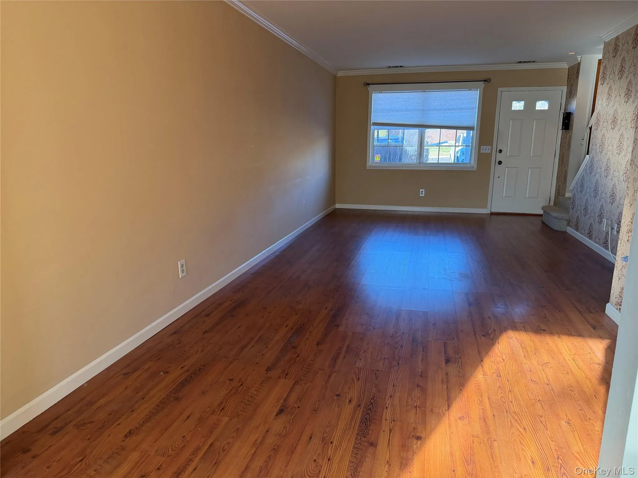 Foyer with wood finished floors and ornamental molding Foyer with wood finished floors and ornamental molding
