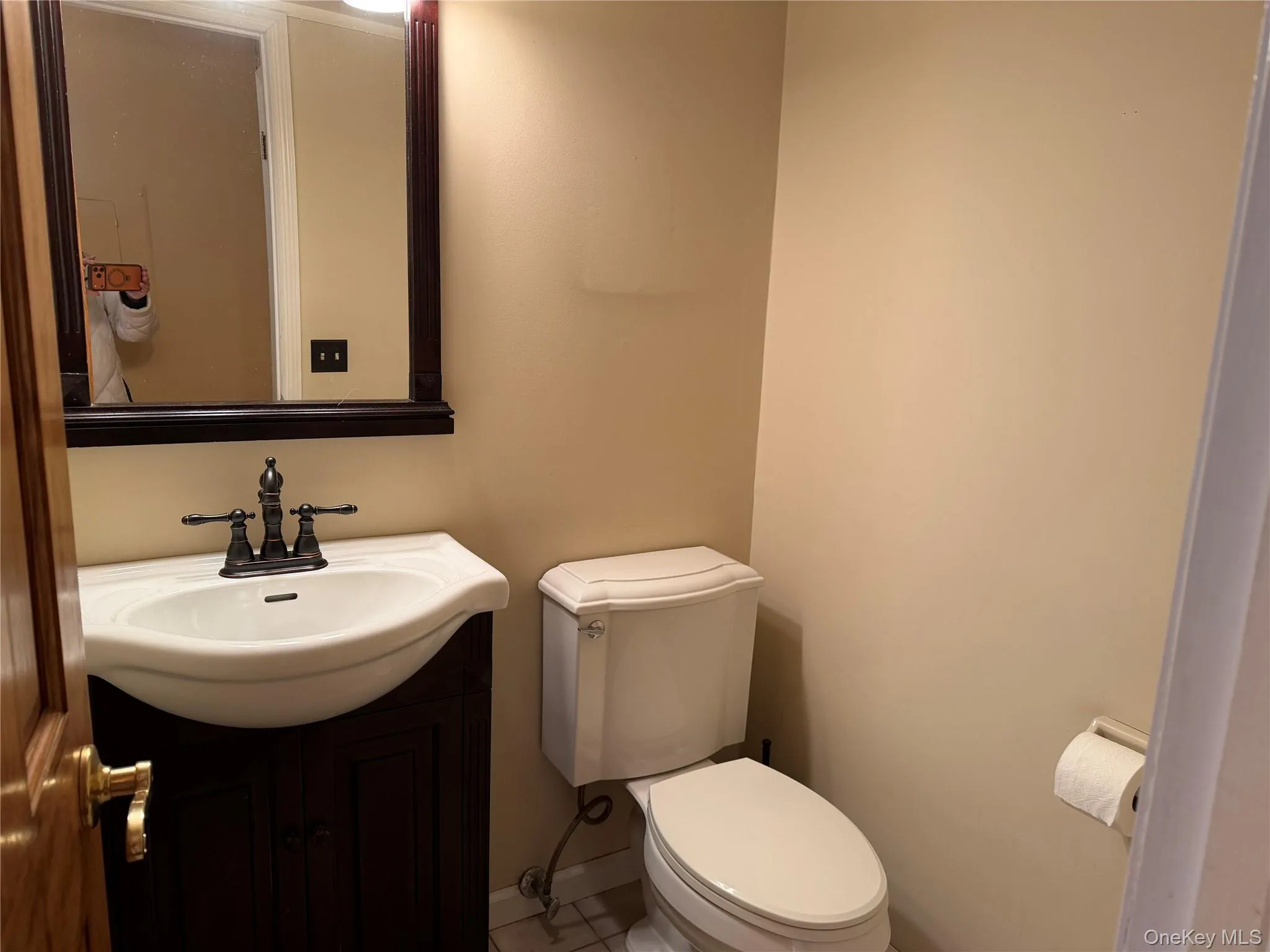Half bath with vanity and tile patterned flooring Half bath with vanity and tile patterned flooring