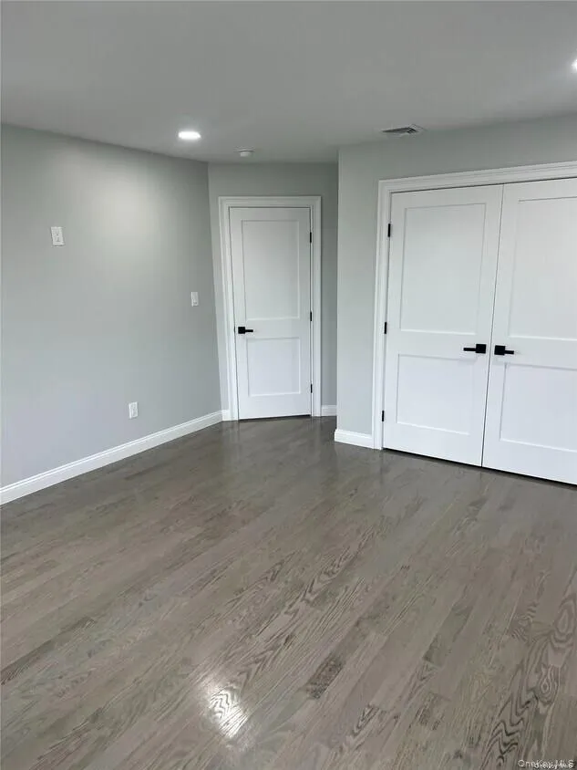 Unfurnished bedroom with recessed lighting, wood finished floors, and a closet Unfurnished bedroom with recessed lighting, wood finished floors, and a closet