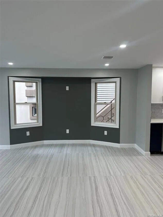 Unfurnished living room featuring healthy amount of natural light and recessed lighting Unfurnished living room featuring healthy amount of natural light and recessed lighting