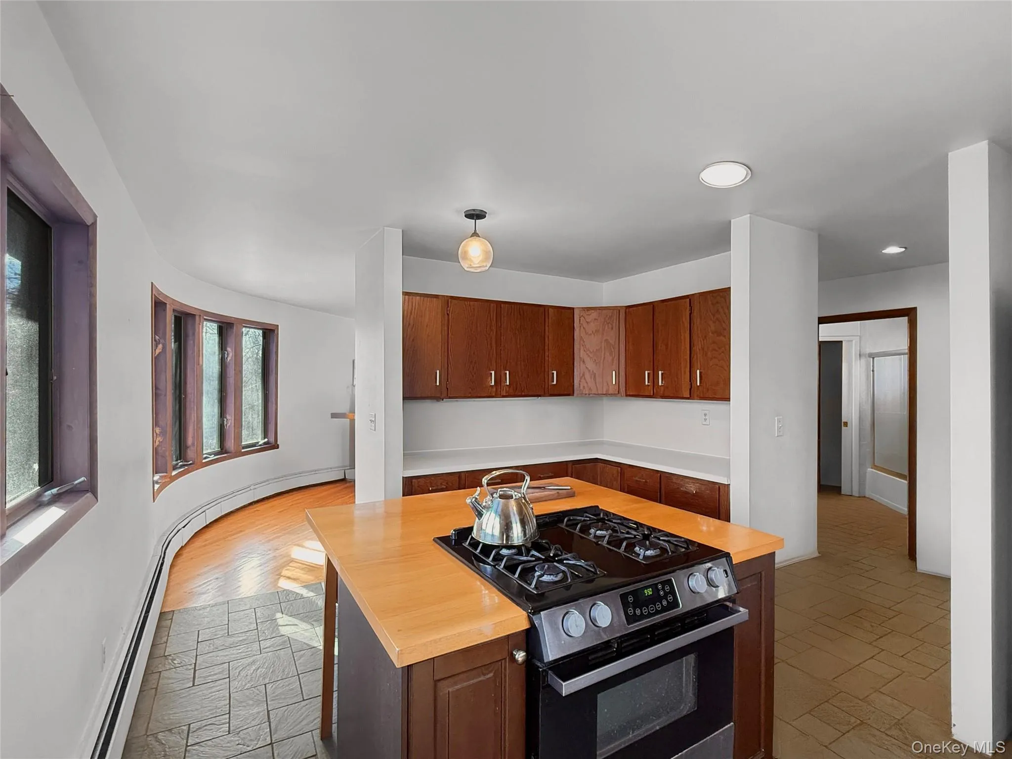 Kitchen with island, updated appliances & access to dining area Kitchen with island, updated appliances & access to dining area