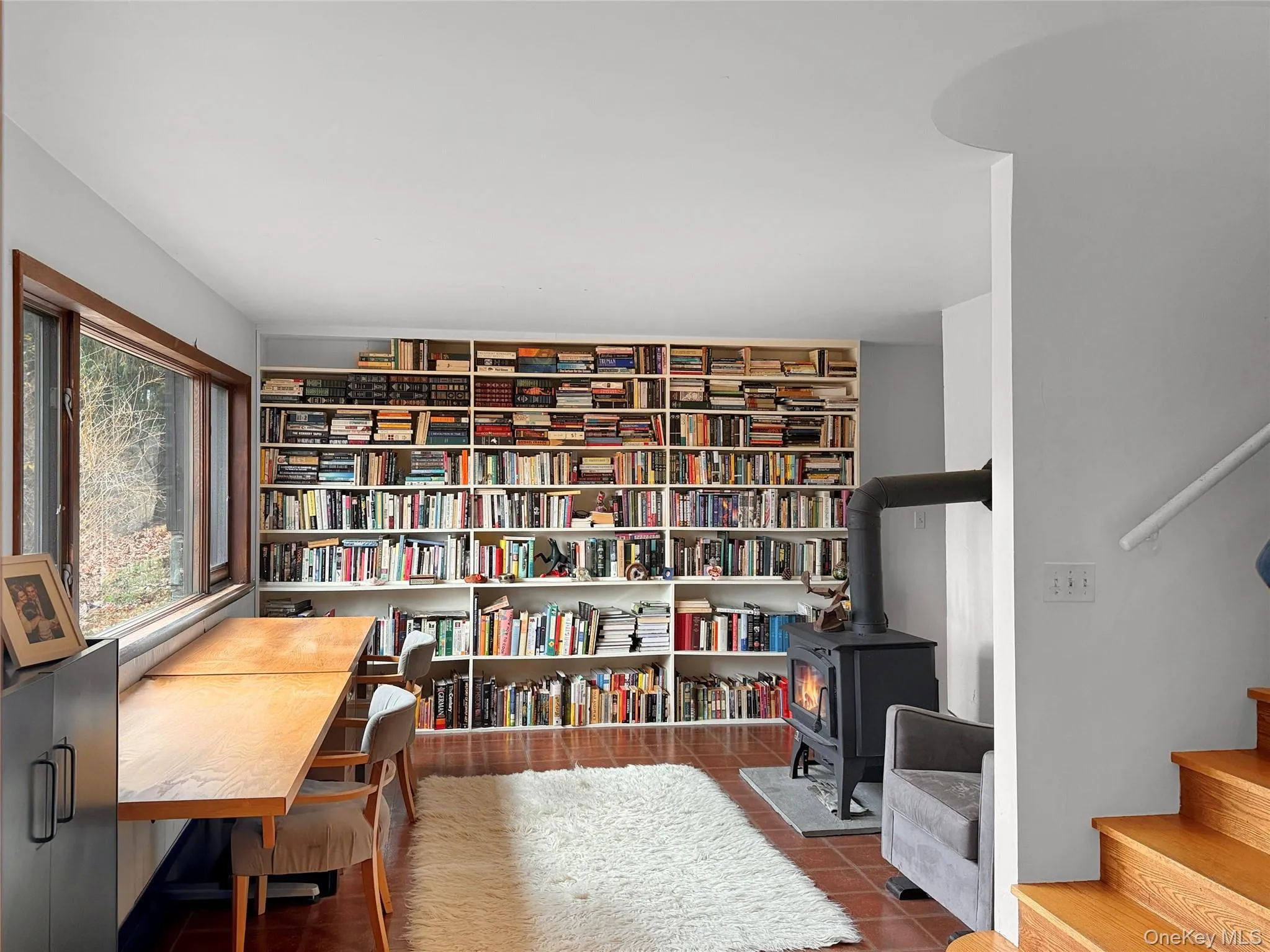 Office/flex space with wood burning stove, radiant floor heating and built-in bookshelves Office/flex space with wood burning stove, radiant floor heating and built-in bookshelves