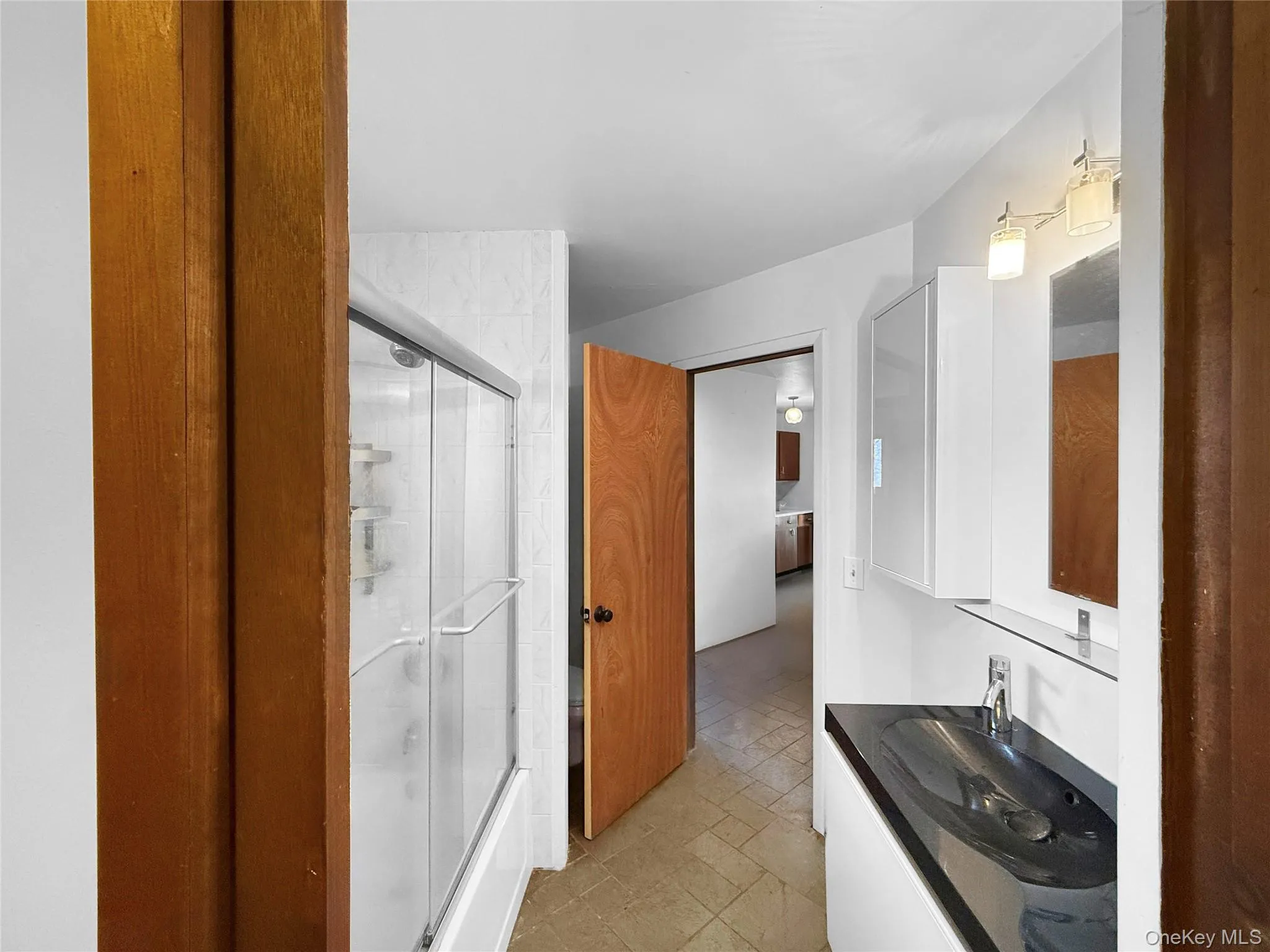 Full bathroom on main floor with walkthrough access to closet Full bathroom on main floor with walkthrough access to closet