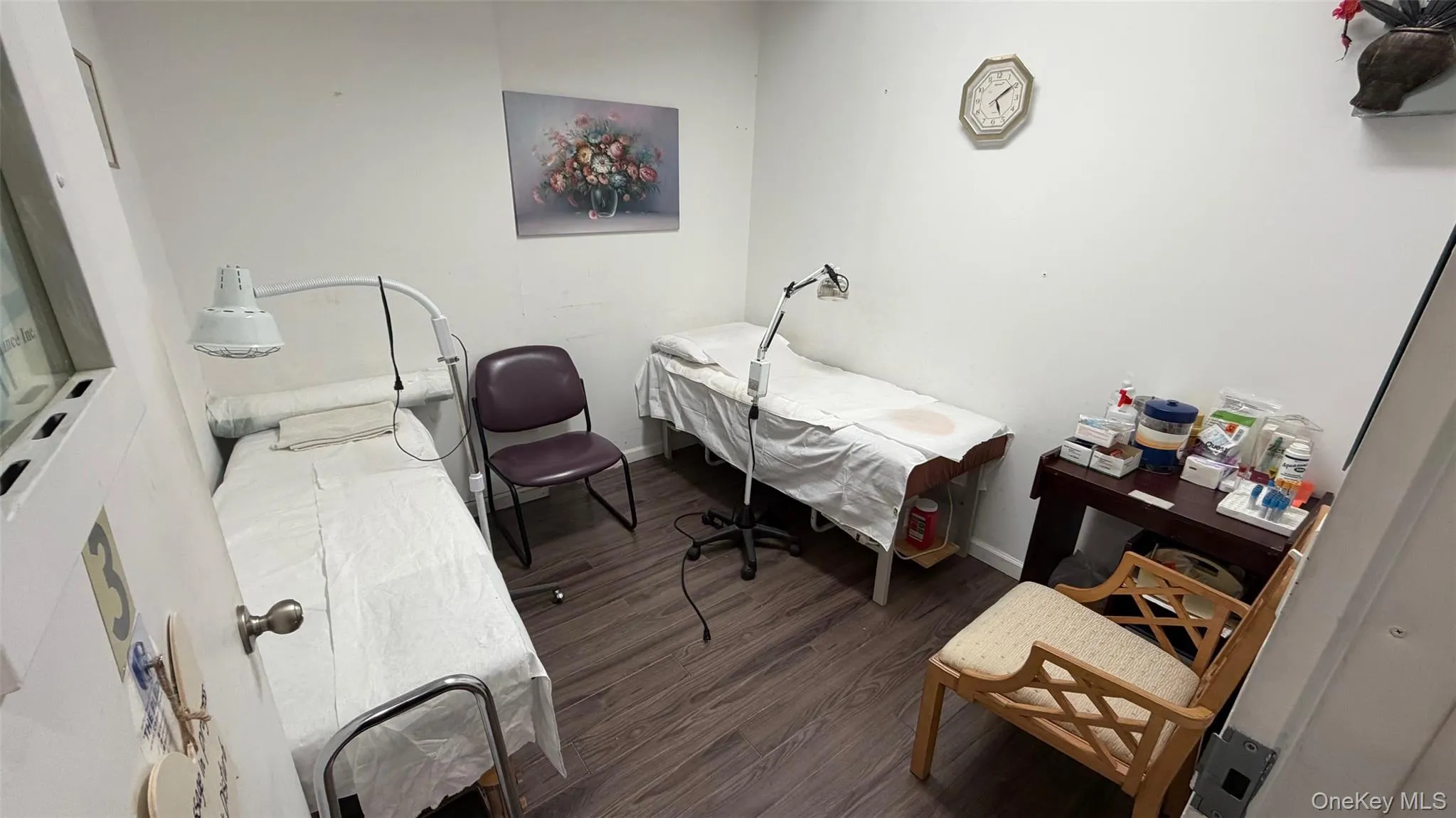 Bedroom featuring dark wood-style floors and baseboards Bedroom featuring dark wood-style floors and baseboards
