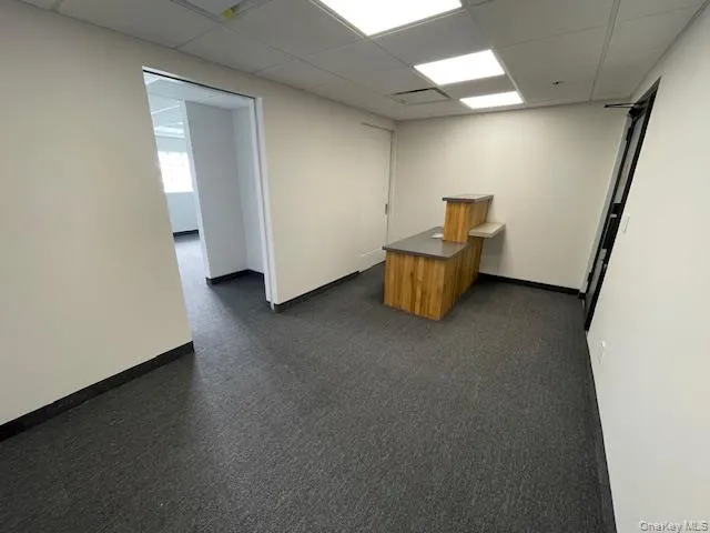 Unfurnished office featuring a drop ceiling Unfurnished office featuring a drop ceiling