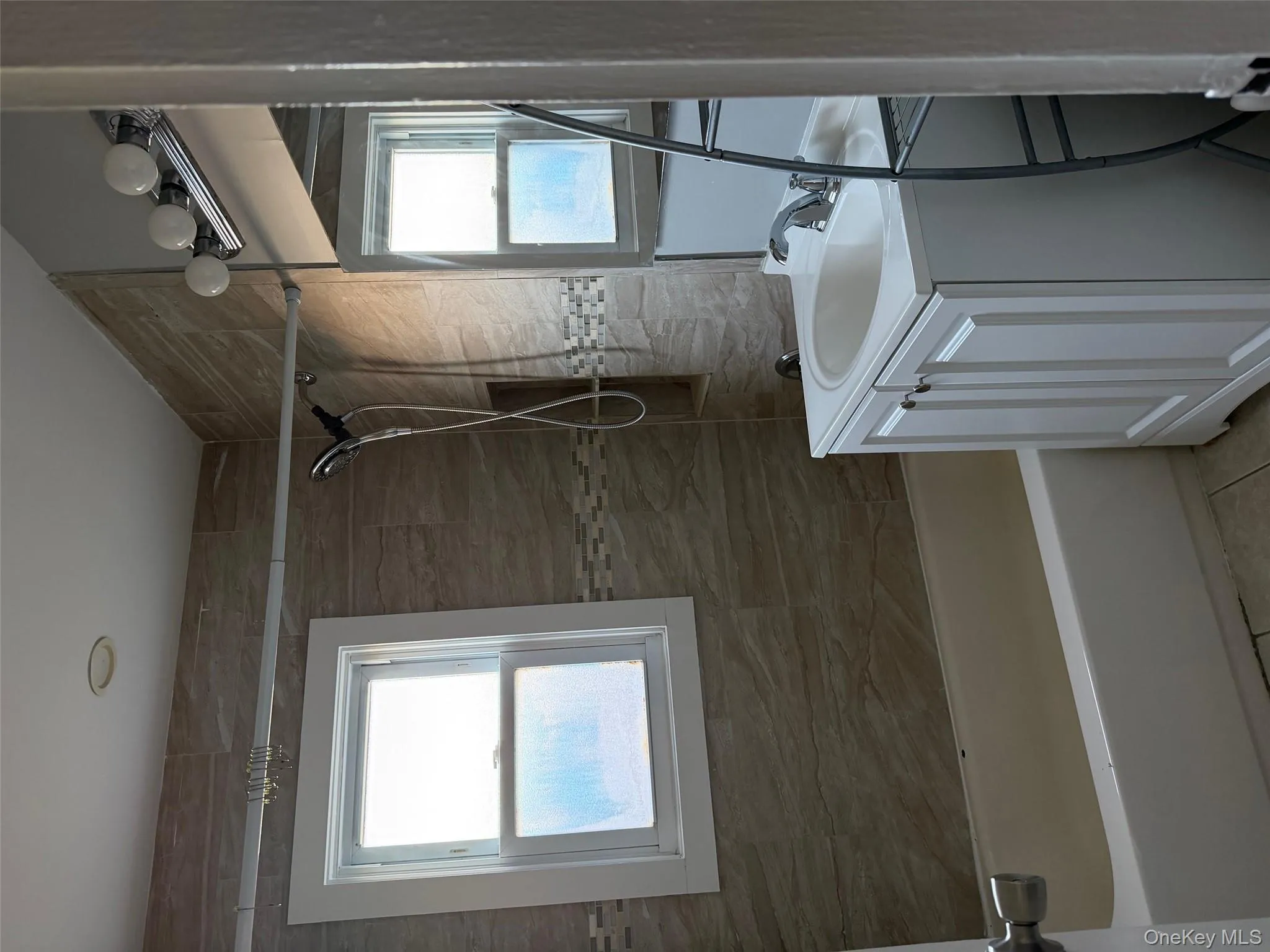 Full bathroom featuring vanity, shower / washtub combination, and light tile patterned floors Full bathroom featuring vanity, shower / washtub combination, and light tile patterned floors