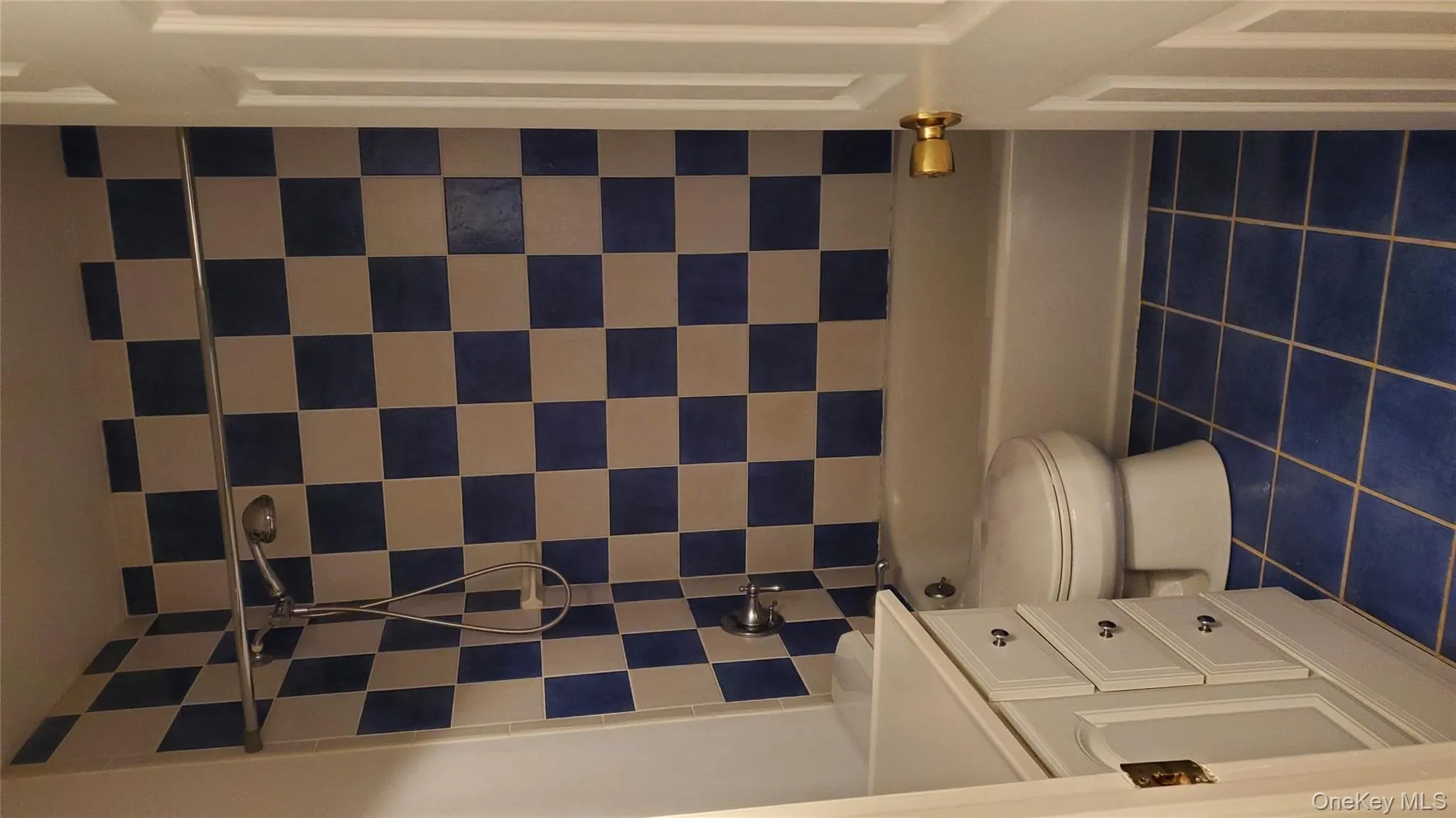 Full bath featuring bathtub / shower combination, dark tile patterned flooring, and vanity Full bath featuring bathtub / shower combination, dark tile patterned flooring, and vanity