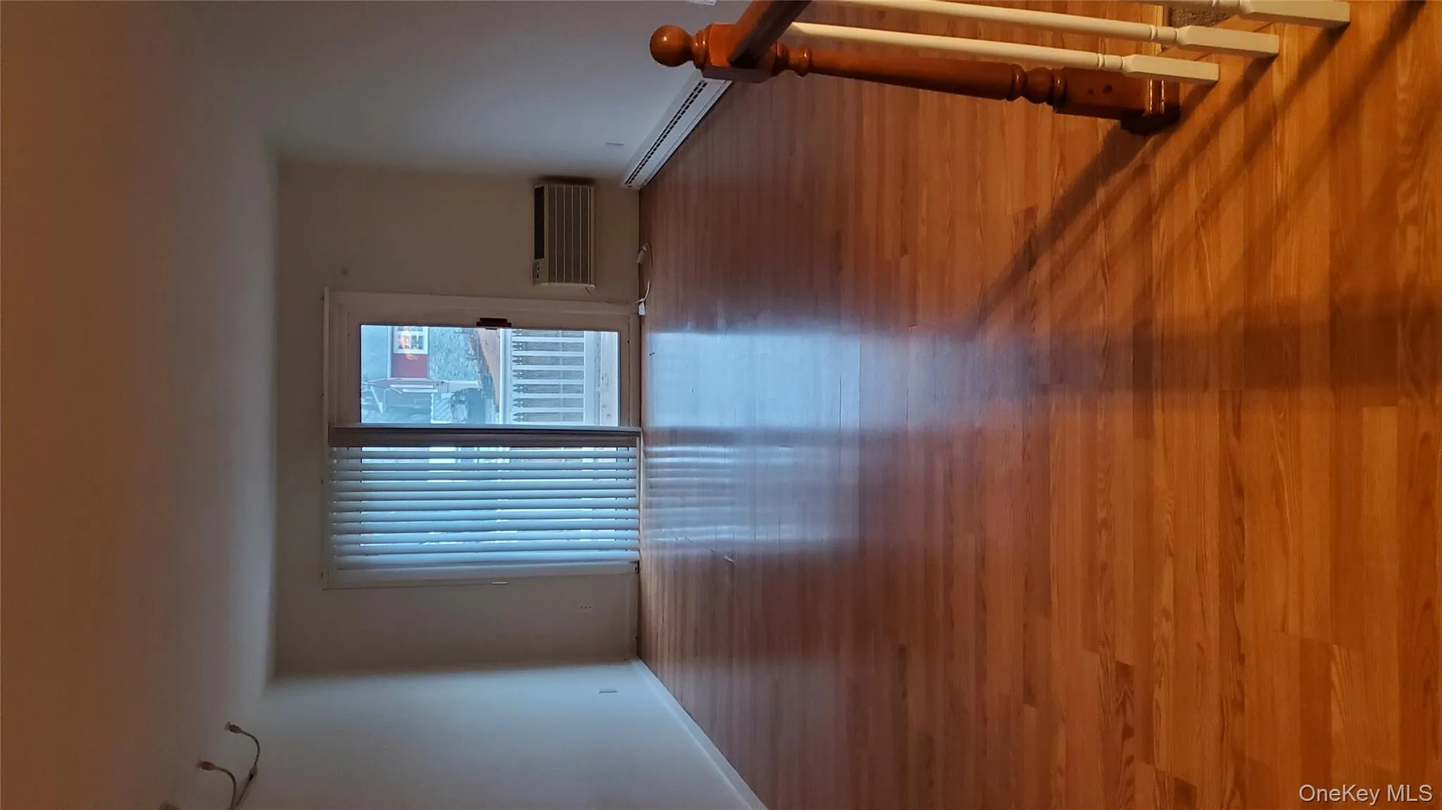 Empty room with baseboard heating and light wood-style floors Empty room with baseboard heating and light wood-style floors