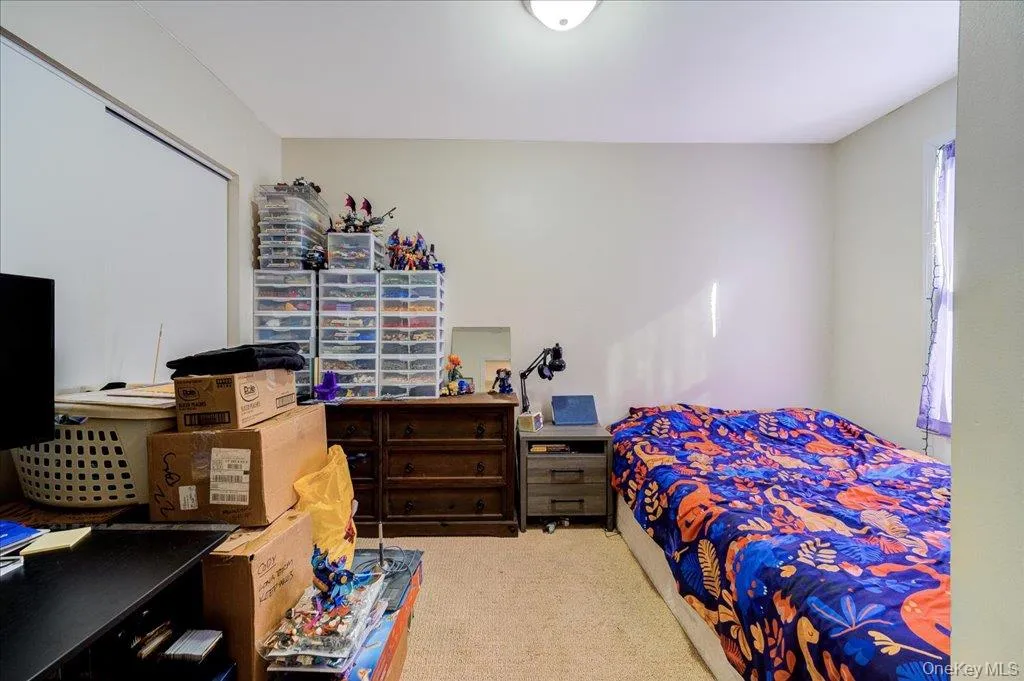 Bedroom featuring light carpet Bedroom featuring light carpet