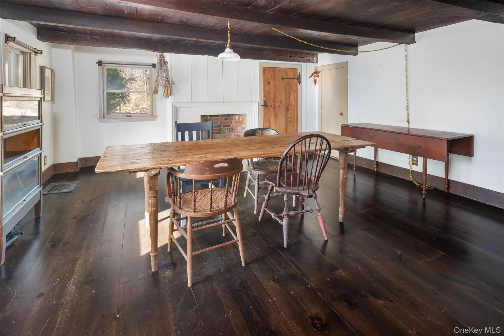 Living room / den off main level entryway with exposed beams and fireplace. Endless possibilities... Living room / den off main level entryway with exposed beams and fireplace. Endless possibilities...