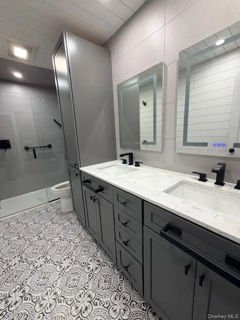 Full bathroom with double vanity and a stall shower Full bathroom with double vanity and a stall shower