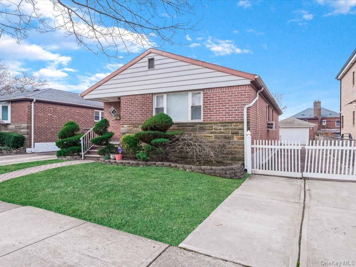 Single story home featuring stone siding and brick siding Single story home featuring stone siding and brick siding