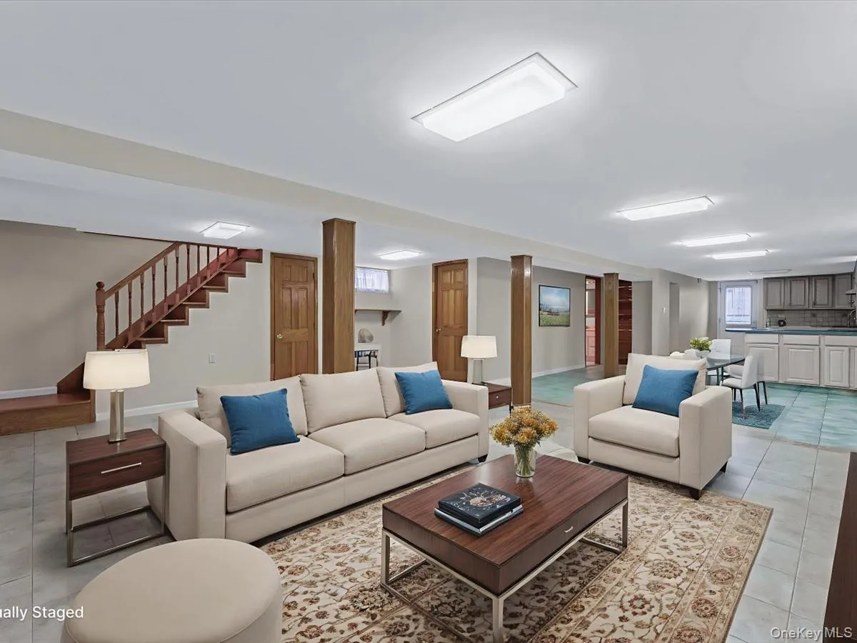 Family room with light tile patterned floors and stairs Family room with light tile patterned floors and stairs