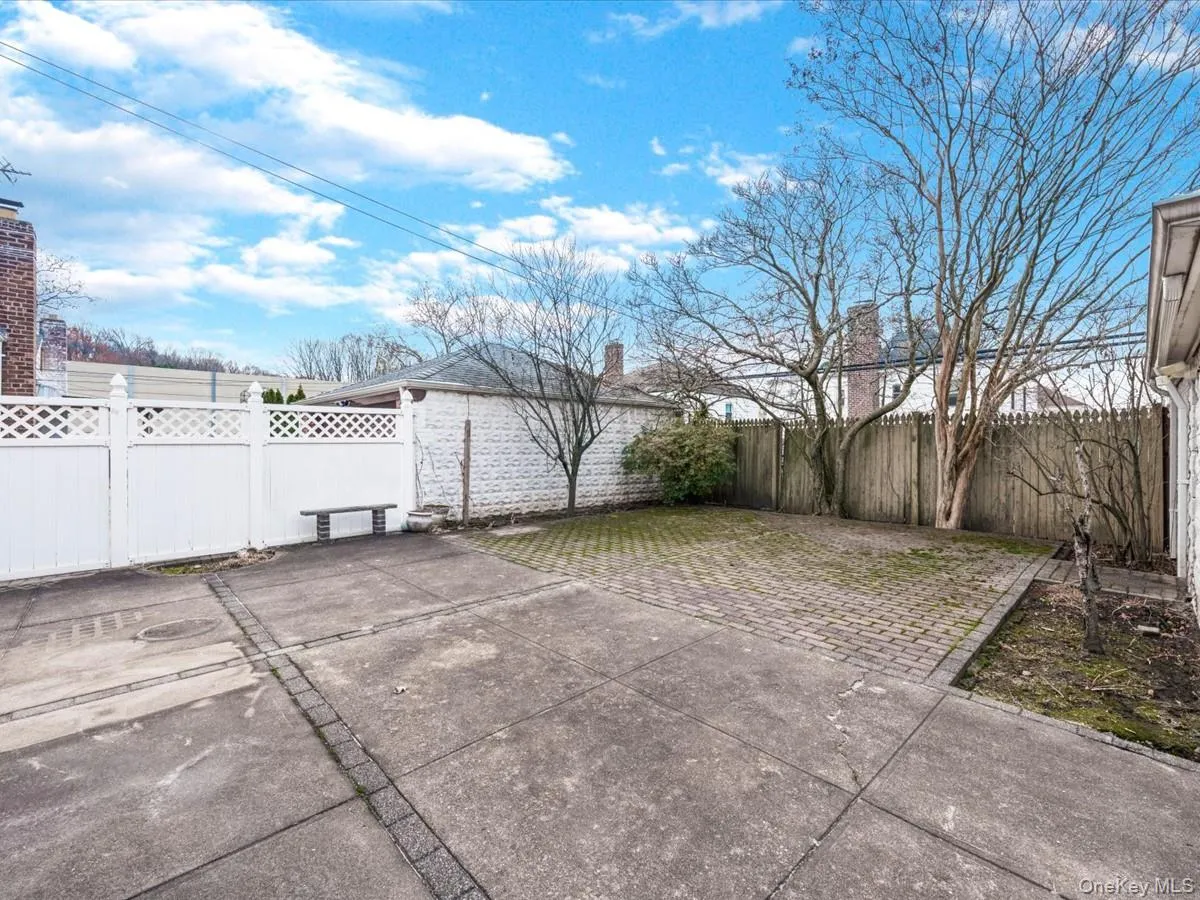Fenced backyard with a patio area Fenced backyard with a patio area