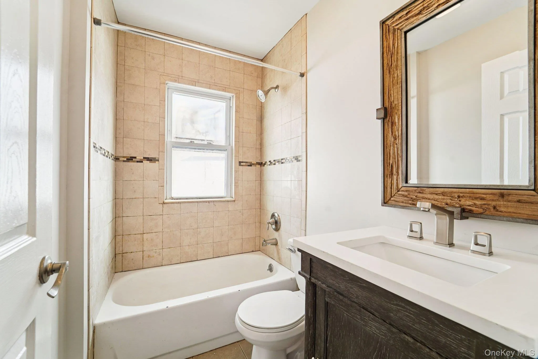 Full bathroom featuring vanity and bathtub / shower combination Full bathroom featuring vanity and bathtub / shower combination