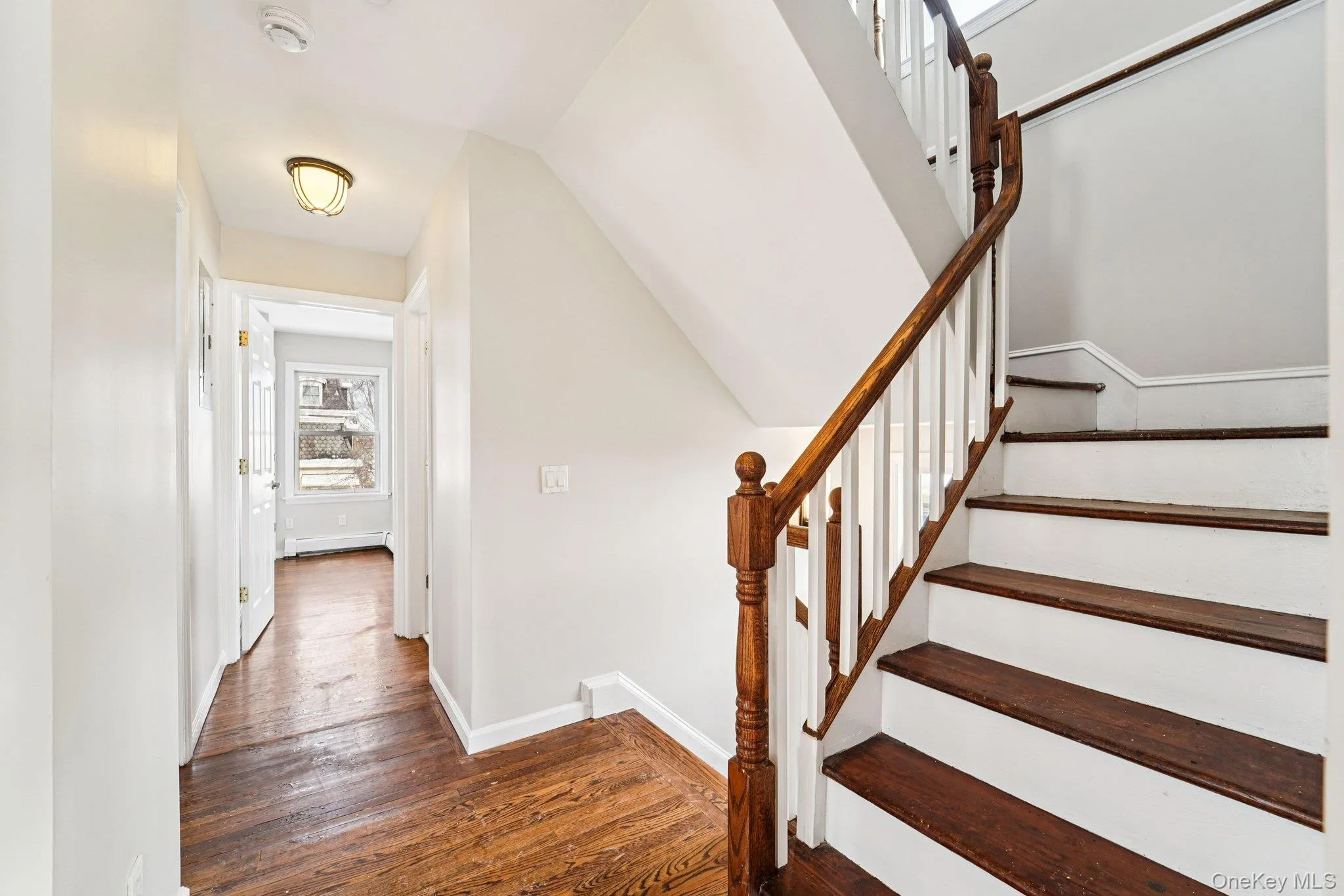 Staircase with hardwood / wood-style floors and baseboards Staircase with hardwood / wood-style floors and baseboards