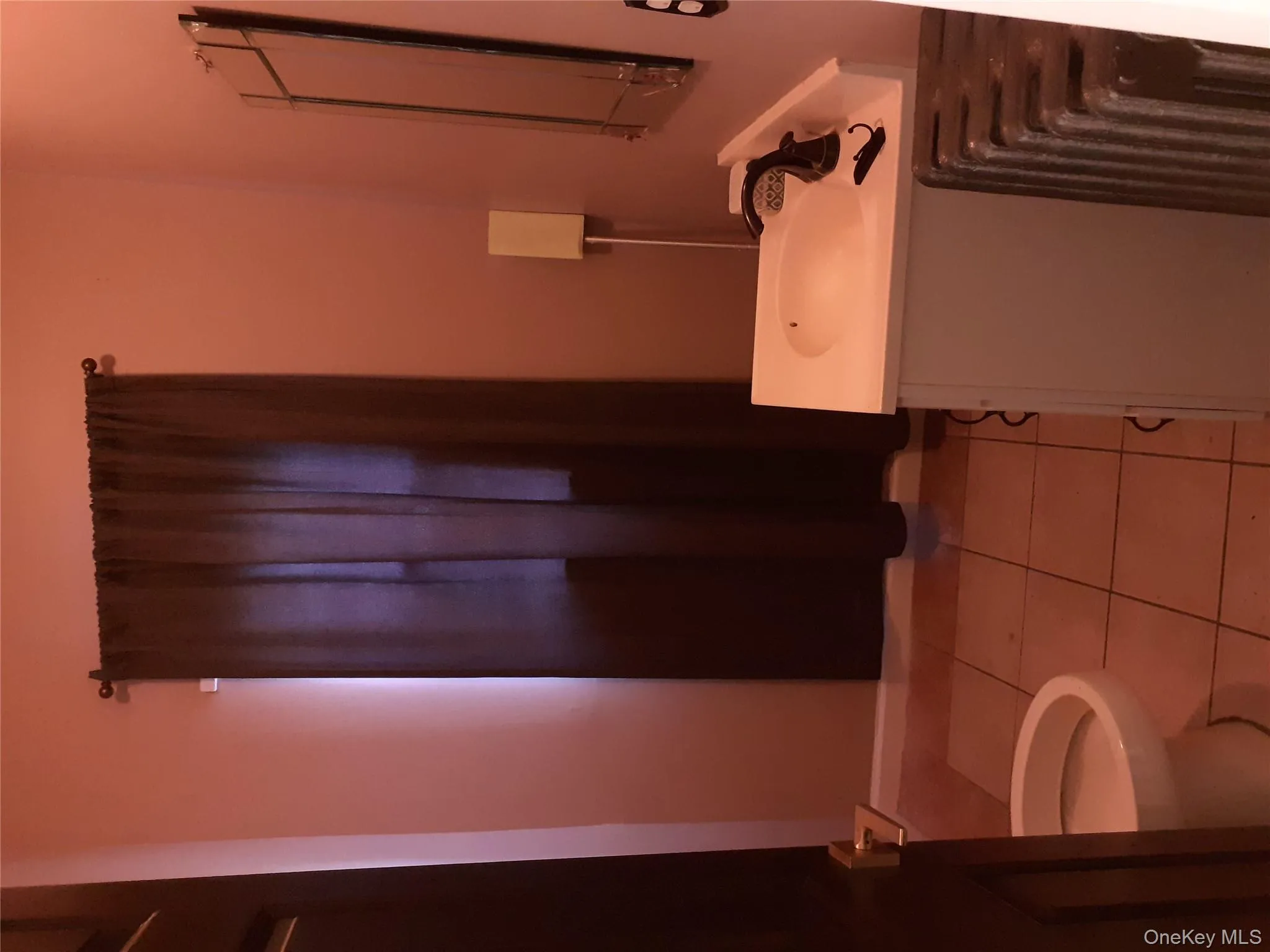 Half bathroom with vanity and light tile patterned floors Half bathroom with vanity and light tile patterned floors