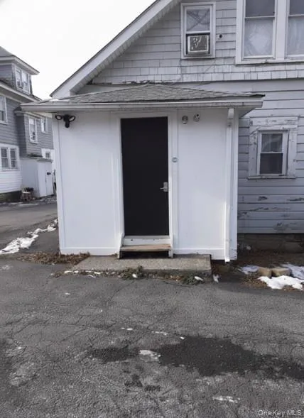 View of exterior entry featuring roof with shingles View of exterior entry featuring roof with shingles
