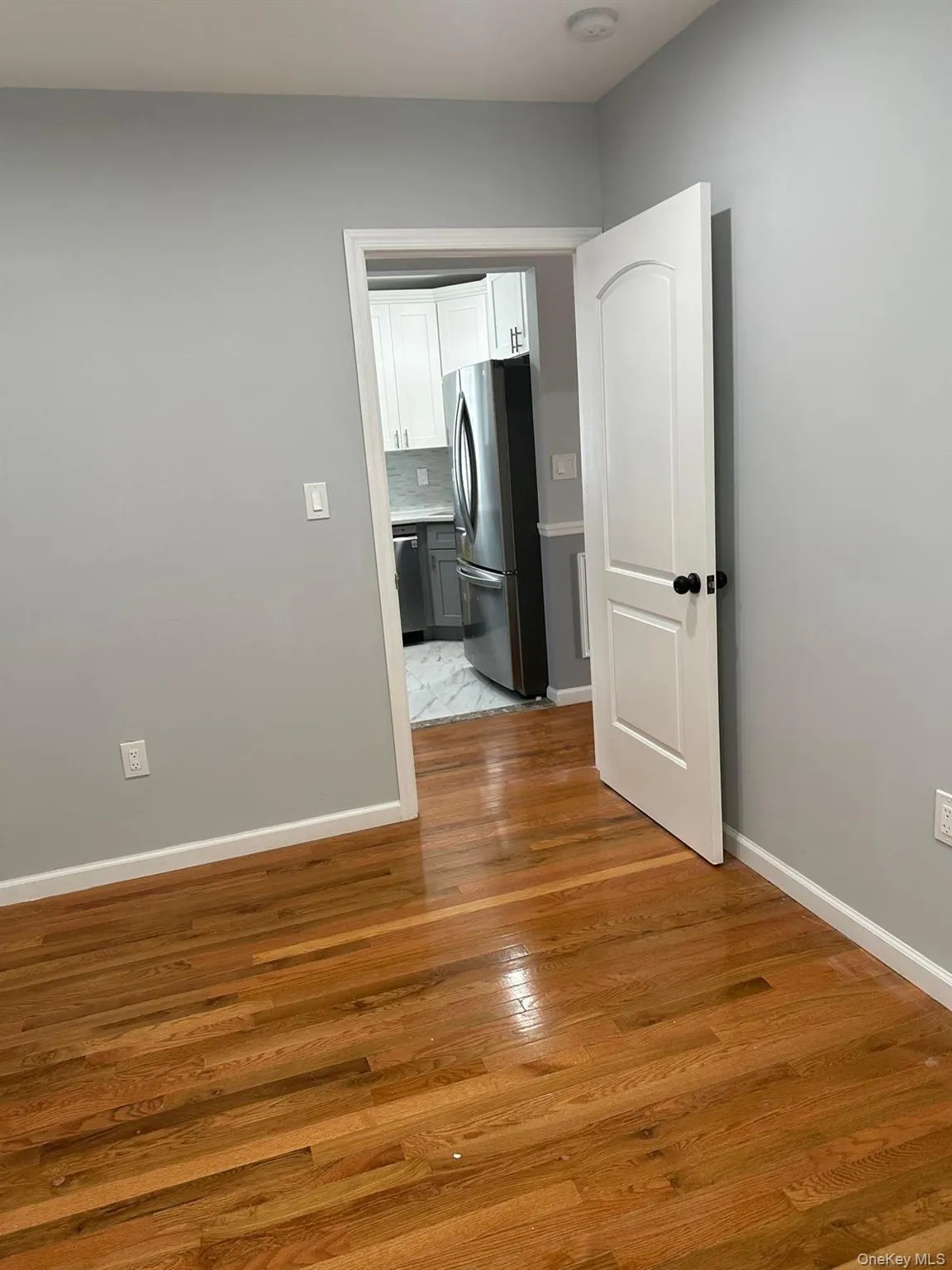 Spare room with light wood-type flooring and baseboards Spare room with light wood-type flooring and baseboards