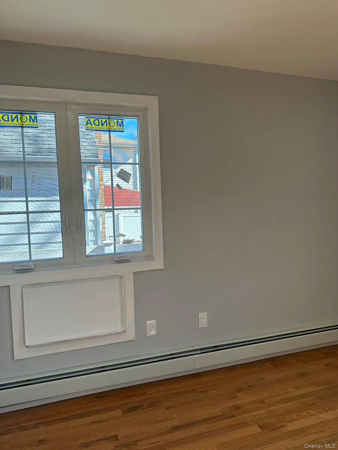 Detailed view of a baseboard radiator and wood finished floors Detailed view of a baseboard radiator and wood finished floors