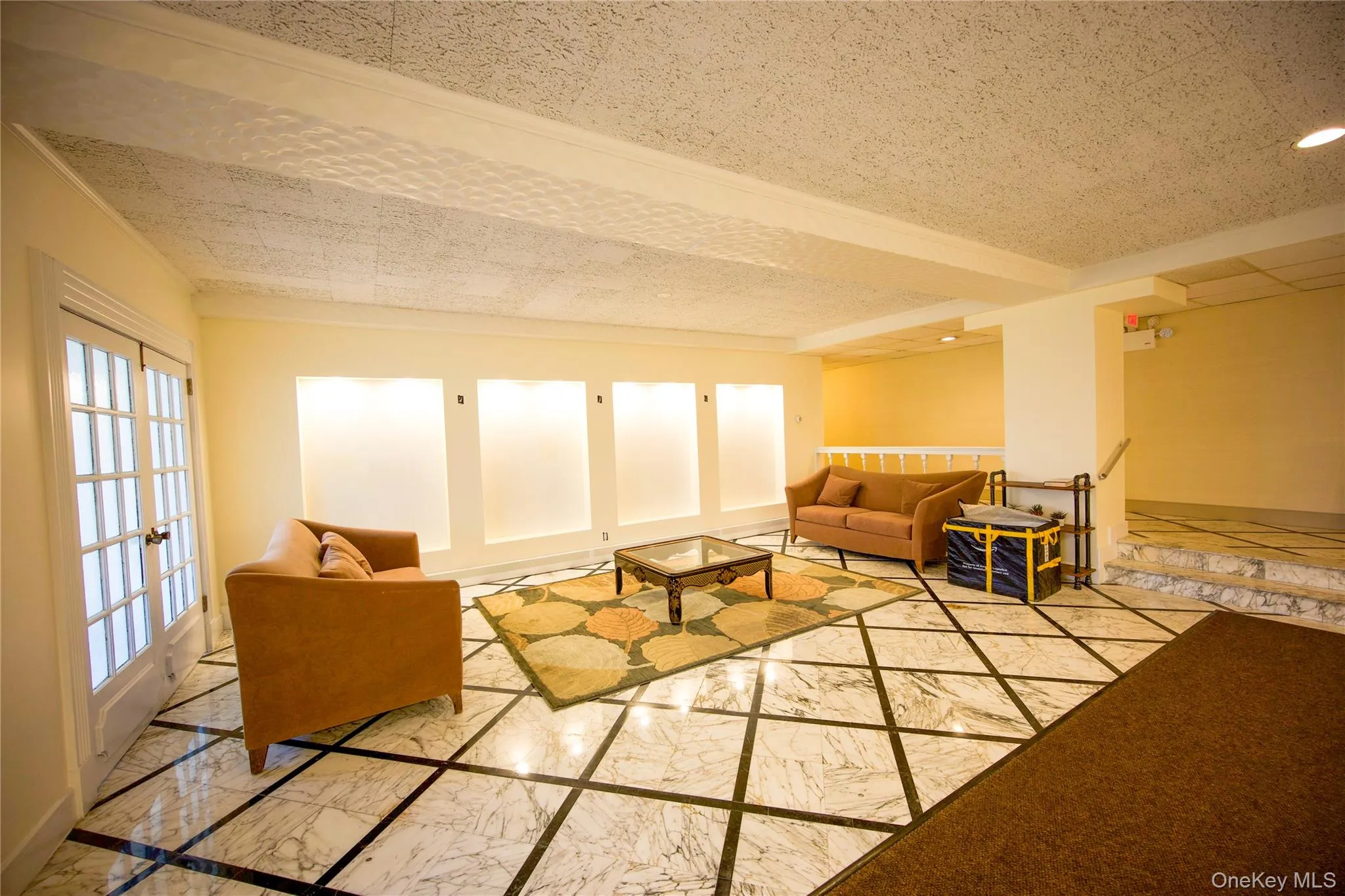 Living room featuring marble tiled floors and baseboards Living room featuring marble tiled floors and baseboards