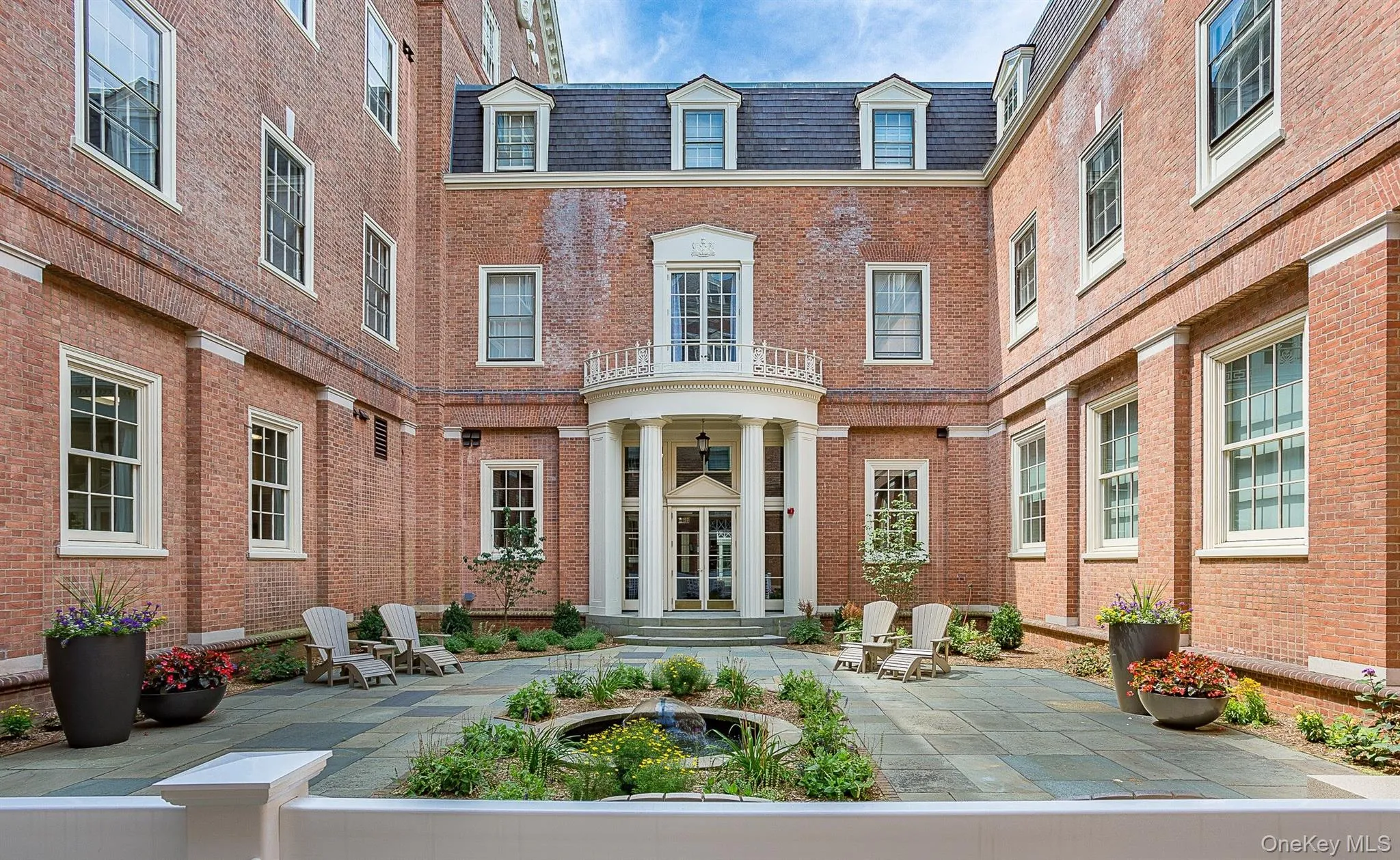Property entrance with brick siding and a patio area Property entrance with brick siding and a patio area