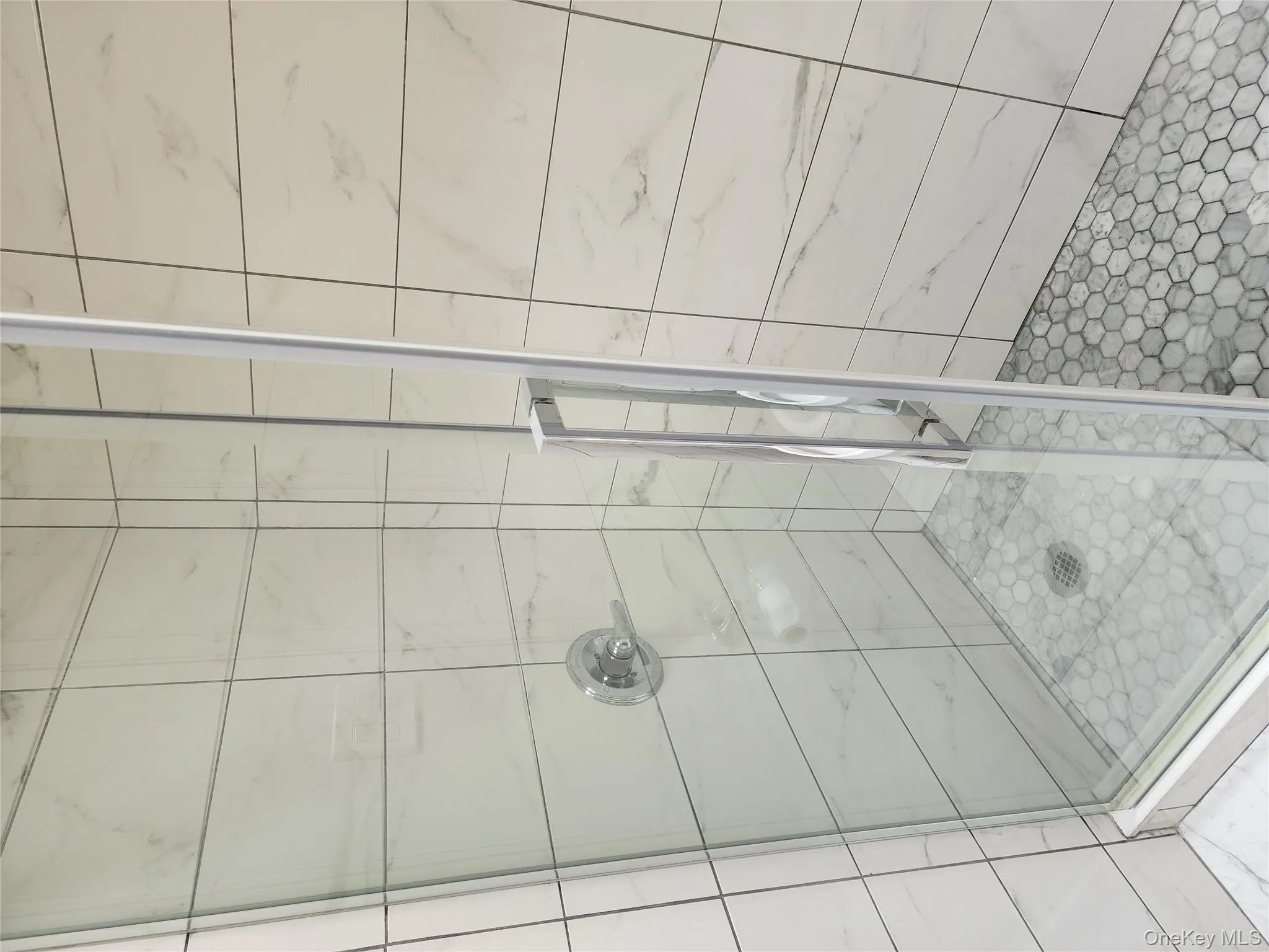 Full bath featuring a shower stall Full bath featuring a shower stall