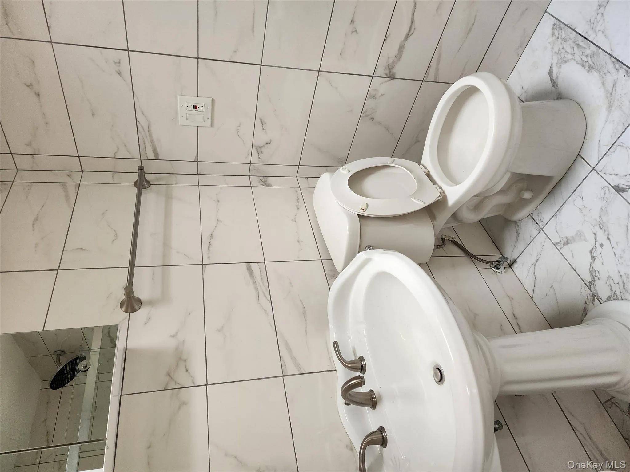 Bathroom with tile walls and marble finish flooring Bathroom with tile walls and marble finish flooring