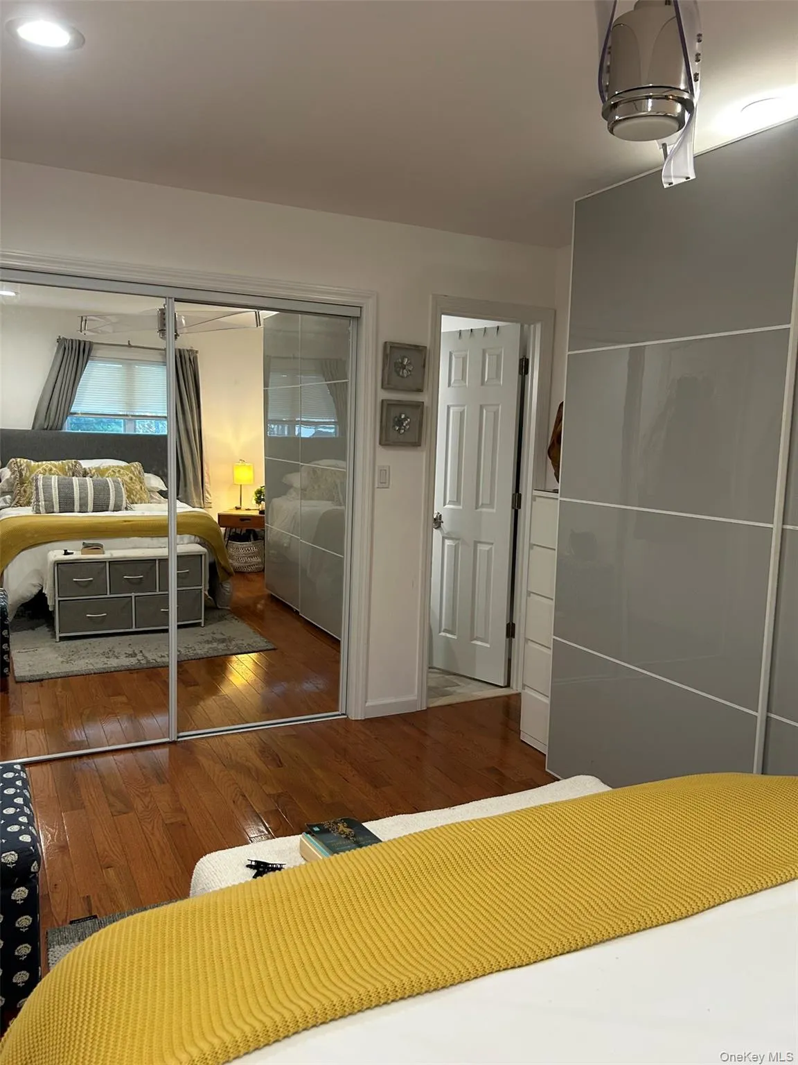 Bedroom featuring a closet and dark wood-style floors Bedroom featuring a closet and dark wood-style floors