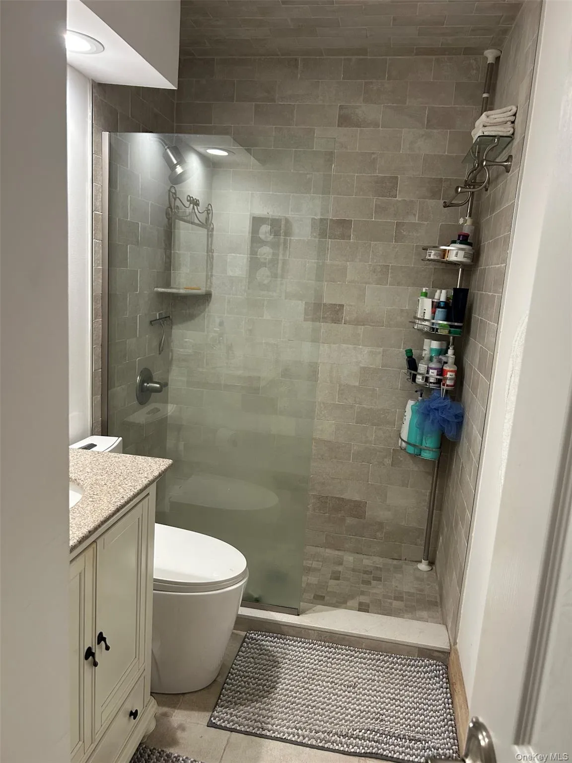 Full bathroom with a walk in shower and vanity Full bathroom with a walk in shower and vanity