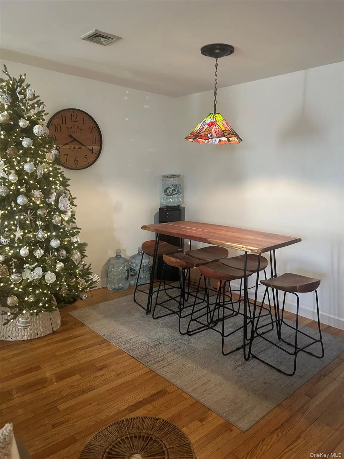 Dining area featuring hardwood / wood-style flooring and baseboards Dining area featuring hardwood / wood-style flooring and baseboards