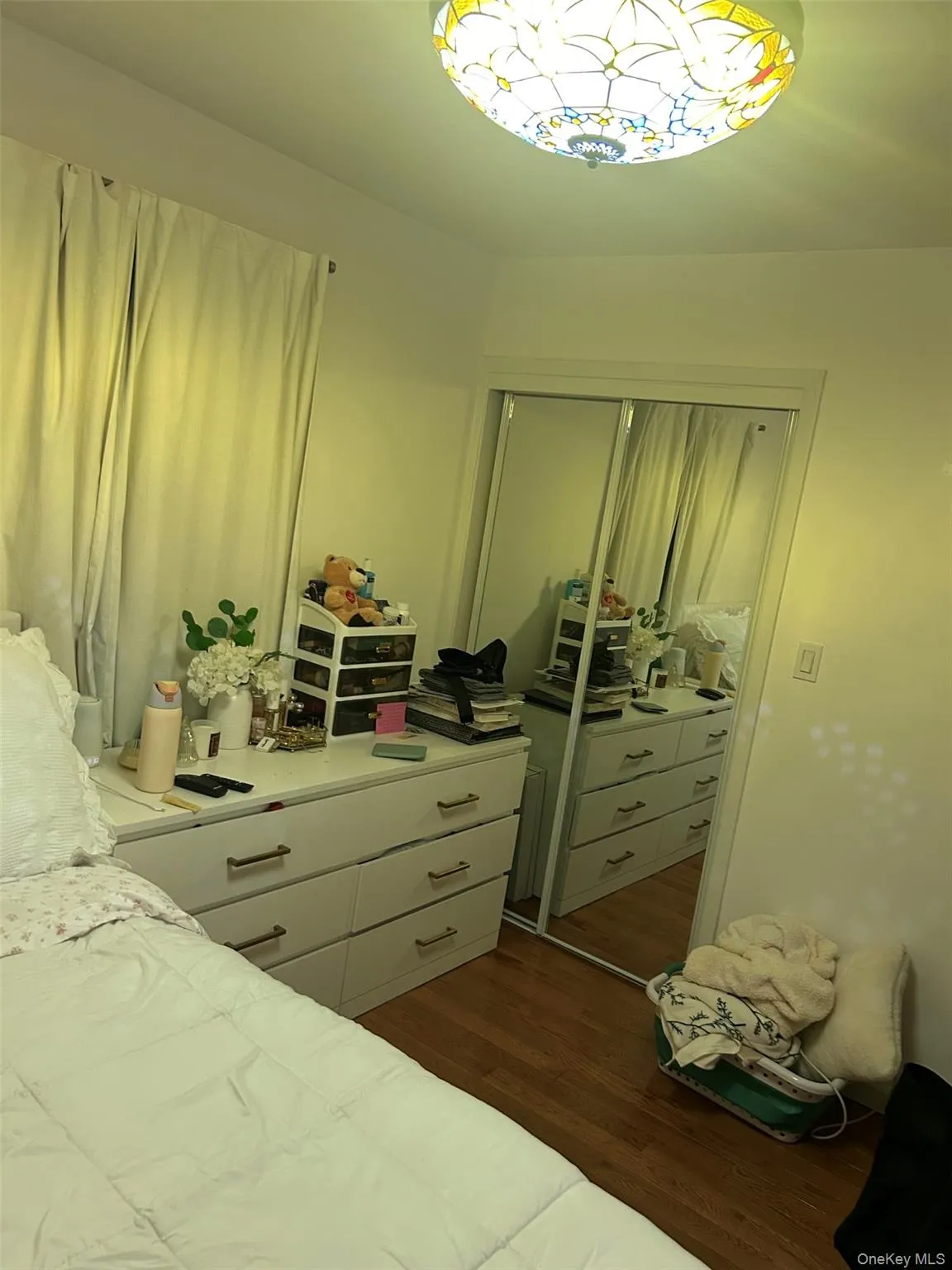 Bedroom with dark wood finished floors and a closet Bedroom with dark wood finished floors and a closet