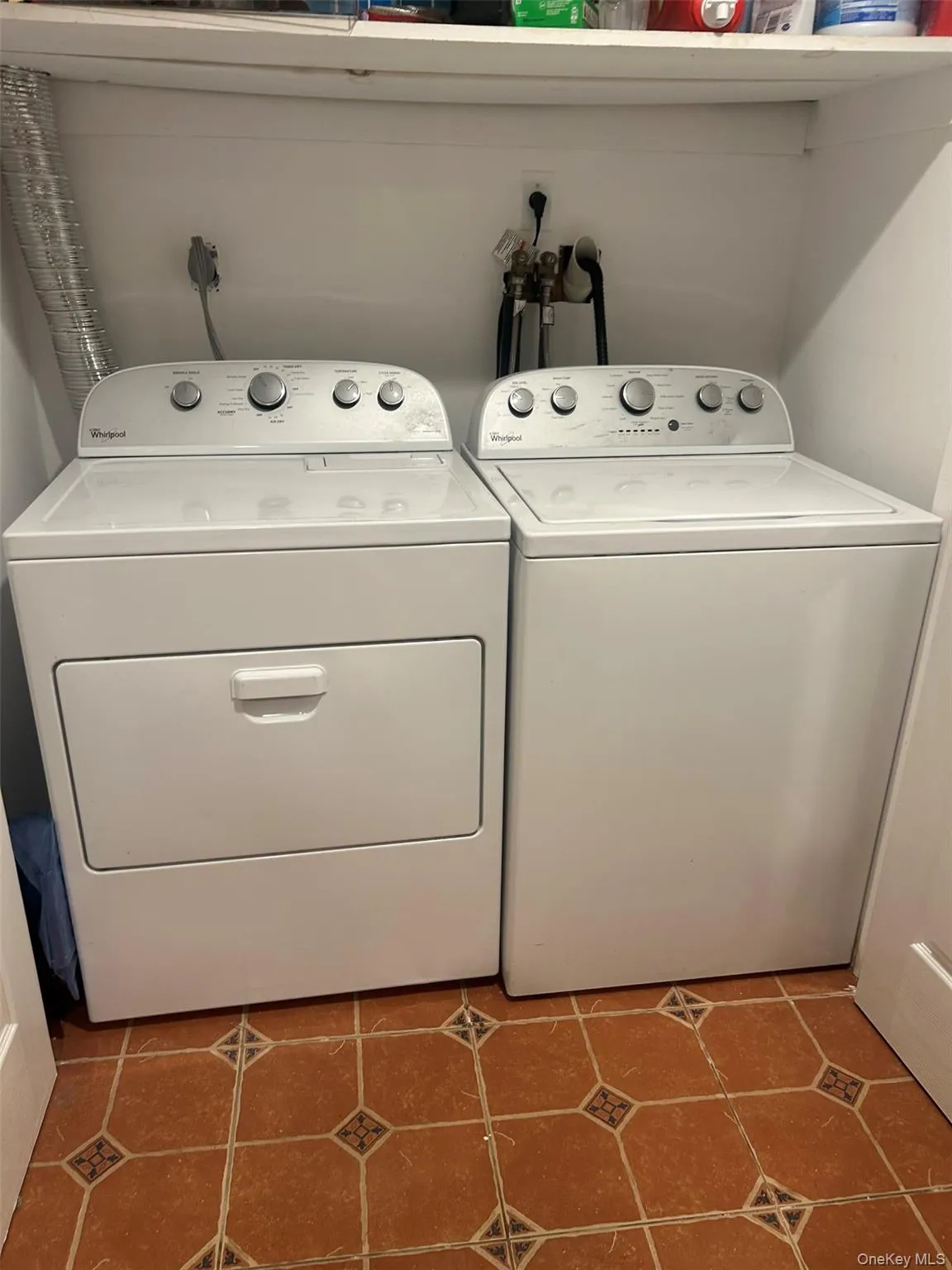 Washroom featuring tile patterned flooring and washer and dryer Washroom featuring tile patterned flooring and washer and dryer